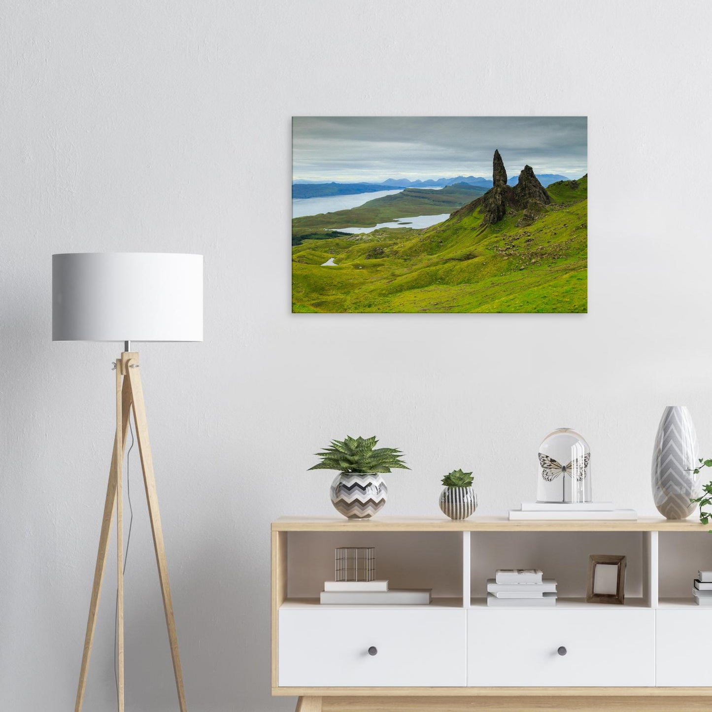 Timeless canvas of The Old Man of Storr with ancient rock columns, green highland views, and reflective waters.
