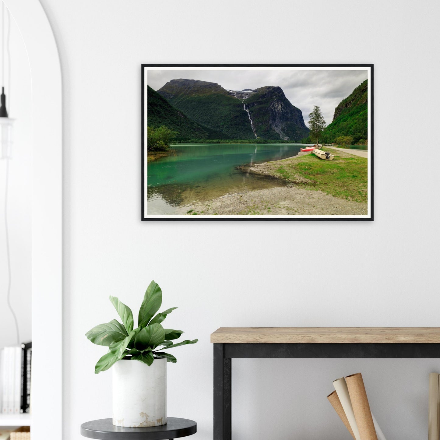 Boats resting by Norwegian lake framed print with waterfall view