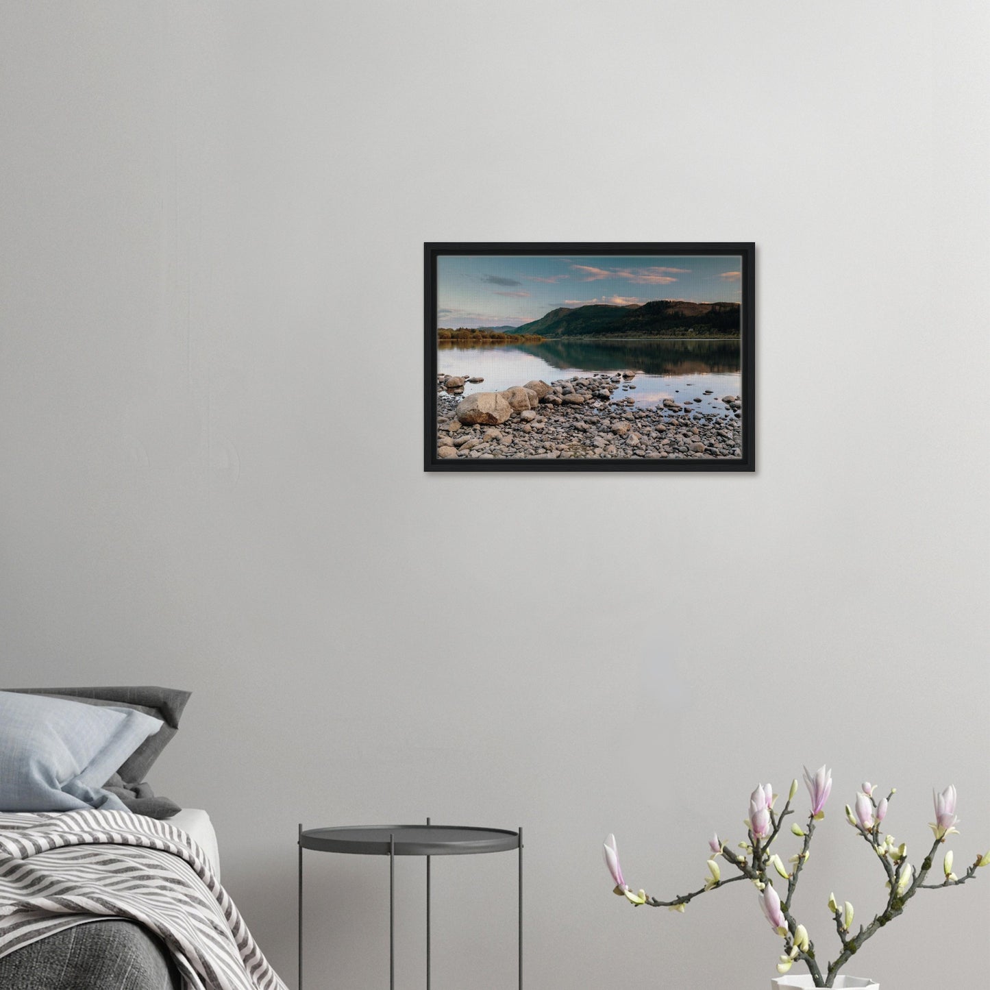 Pebble shoreline leading to calm waters in the Lake District