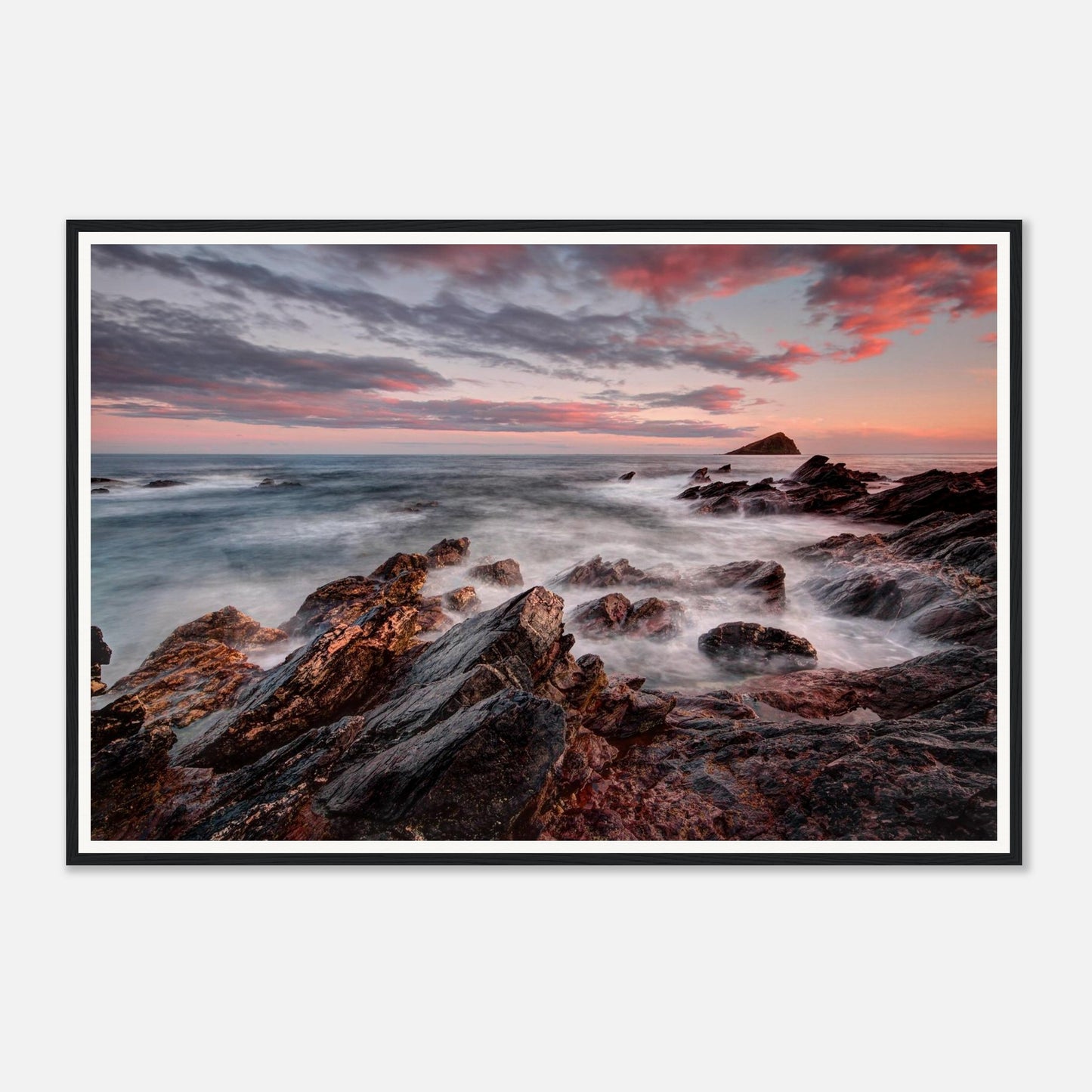 Evening light casting pink and orange sky over Wembury Beach
