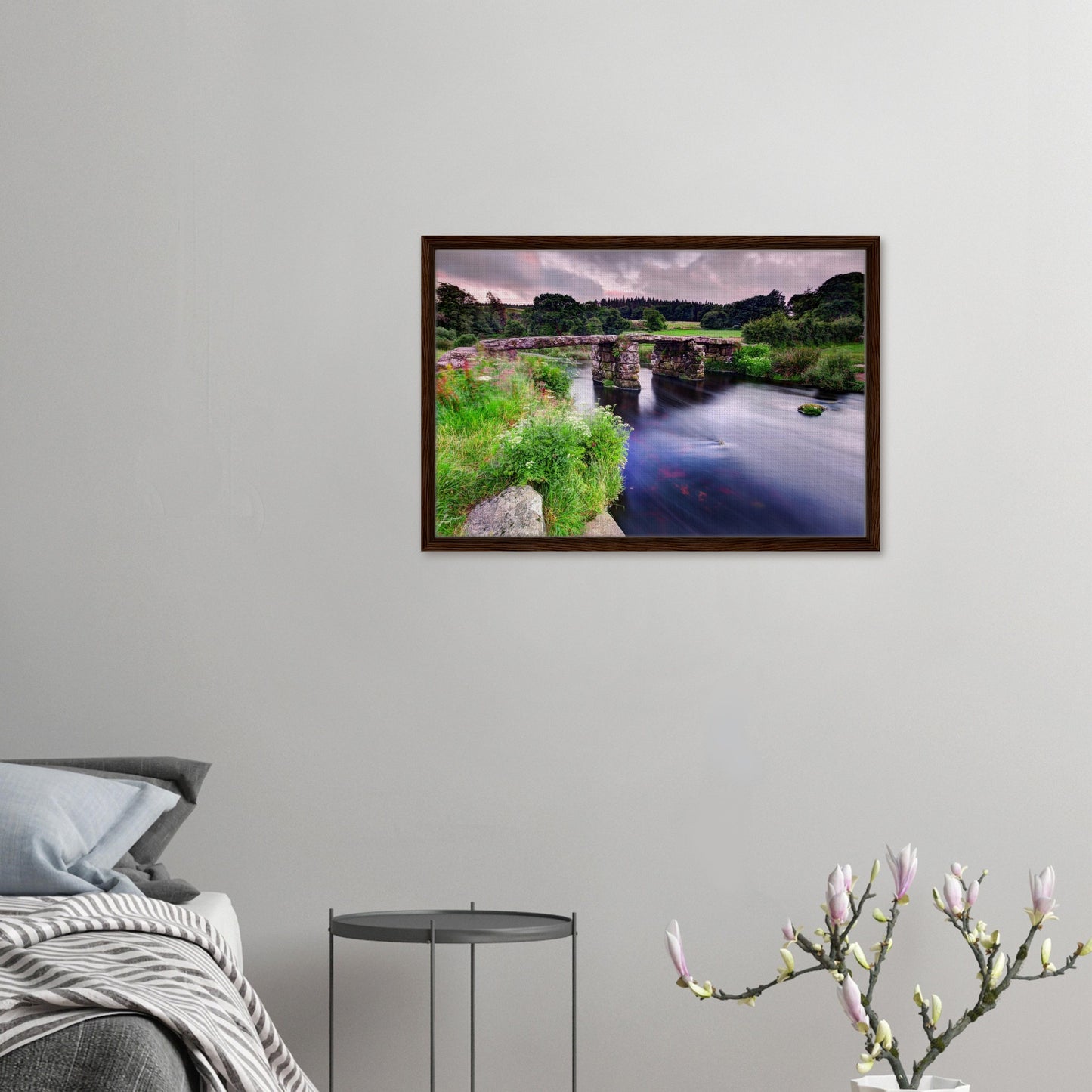 Lush green Dartmoor landscape with clapper bridge in frame