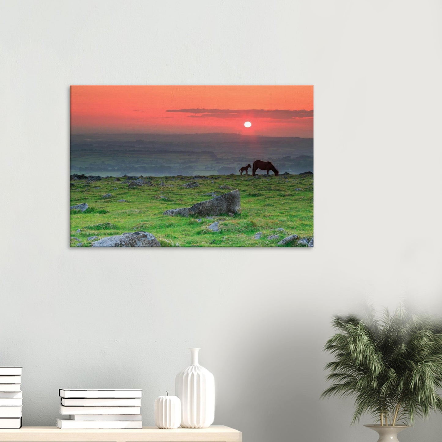 Canvas artwork of Dartmoor landscape with grazing horses in red and orange twilight.