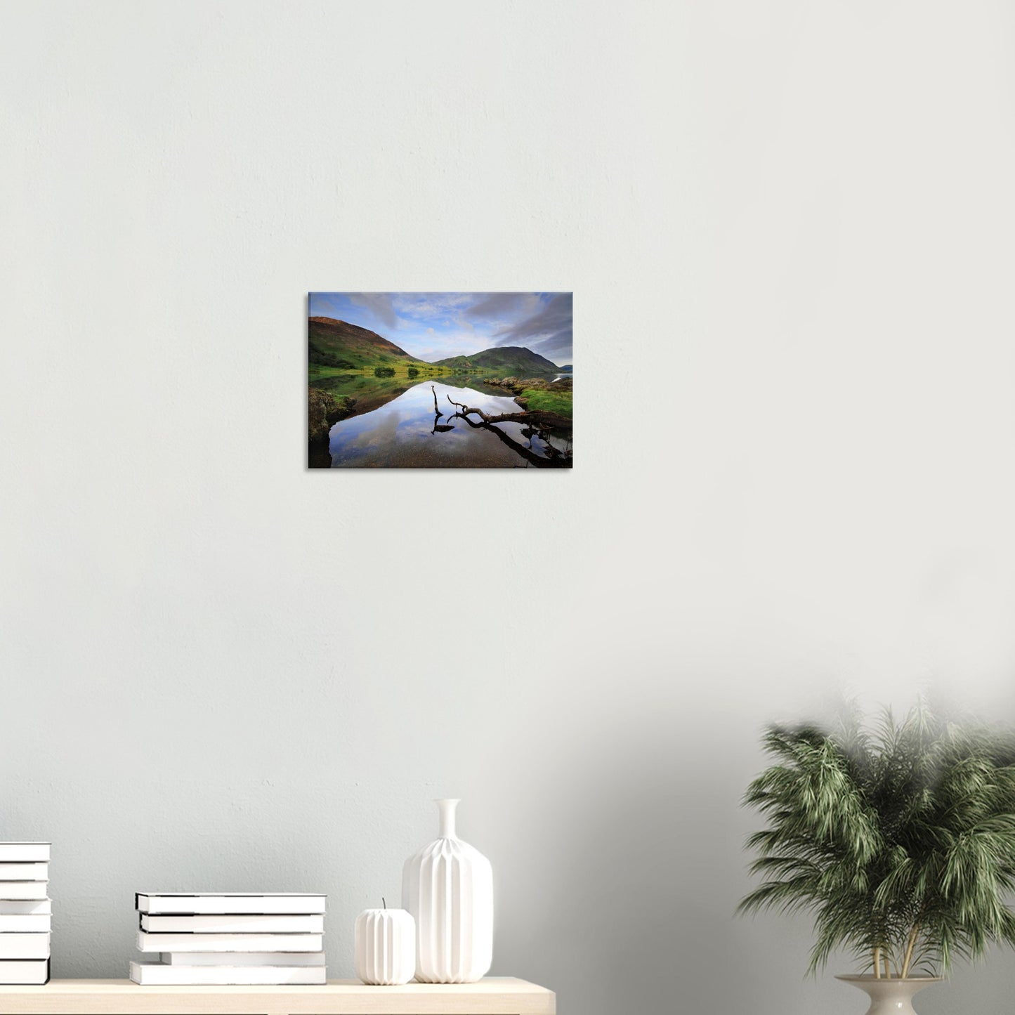 Canvas depicting tranquil Crummock Water in the Lake District, with a natural branch on the shore and perfectly reflected hills and sky.