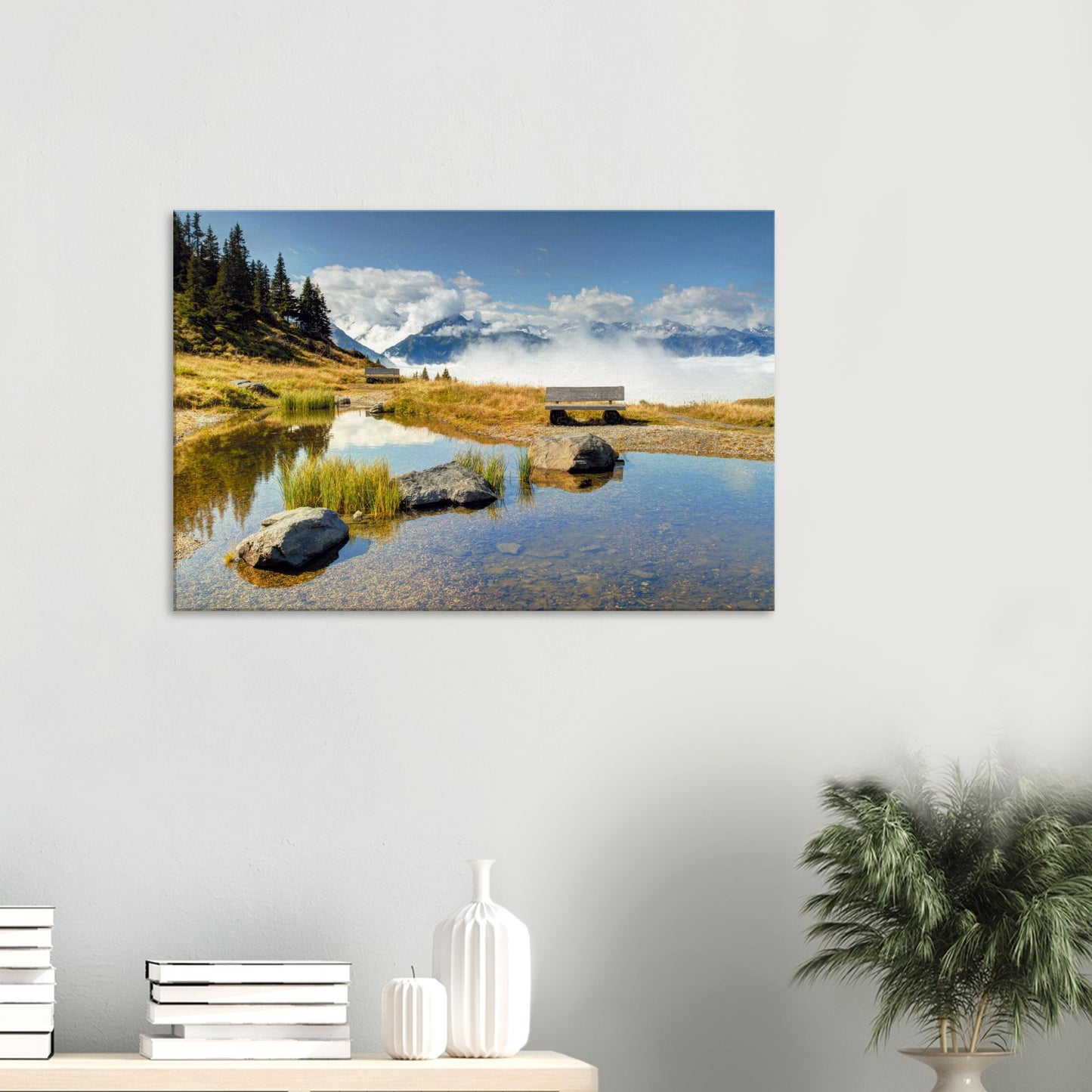 Austrian Alps canvas print with a reflective pond, peaceful bench, and dramatic mountain backdrop partially obscured by clouds.