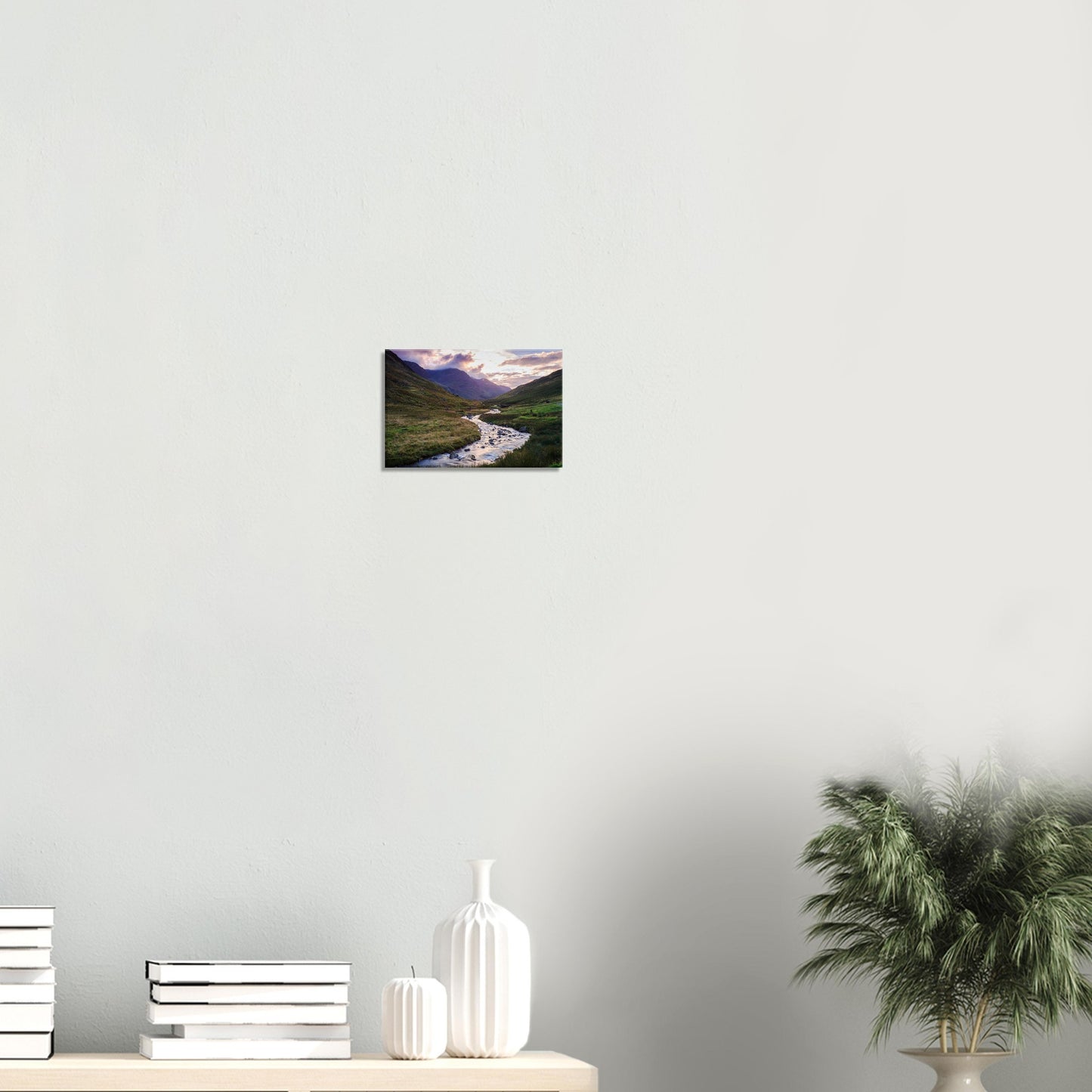 Canvas wall art of Honister Pass showing a sunlit valley with a winding brook and cloud-shrouded mountains under soft light.