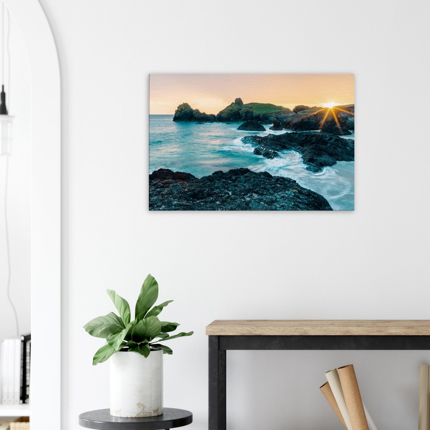 Gentle waves breaking around jagged rocks during sunset at this iconic Cornish location