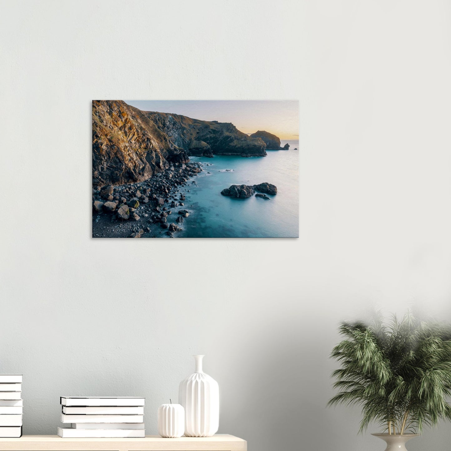Mullion Cove at dusk with sunlit cliffs and peaceful ocean reflections