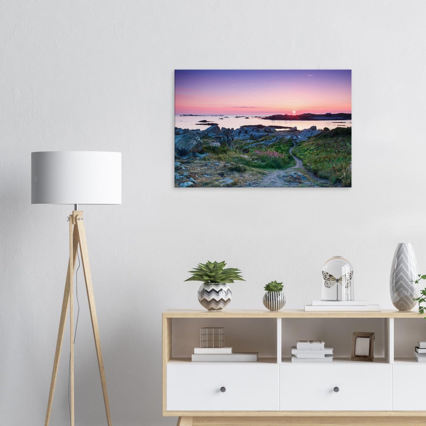 Peaceful sunset canvas of Lihou Island in Guernsey with soft light reflecting off tide pools and blooming wildflowers.