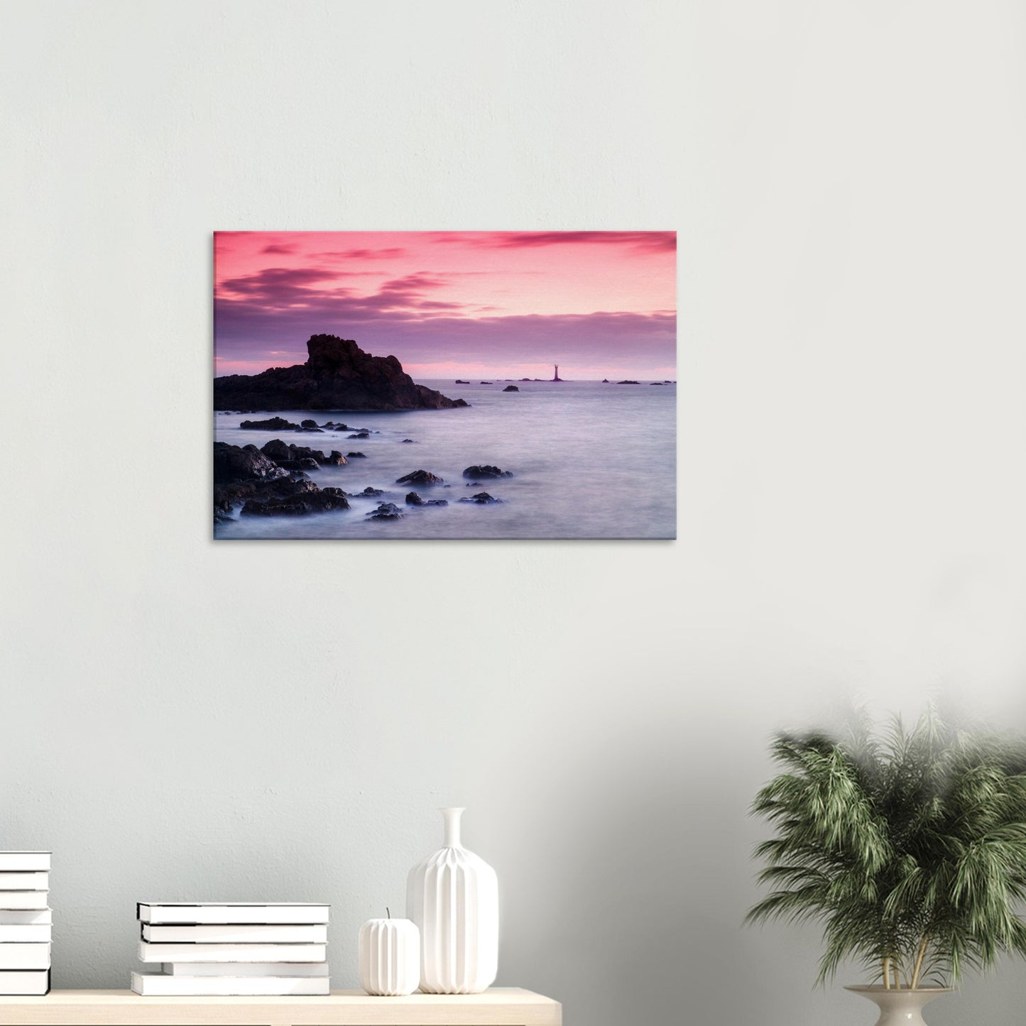 Evening canvas print of Les Hanois Lighthouse with a serene coastal foreground and a glowing pink and purple sky.