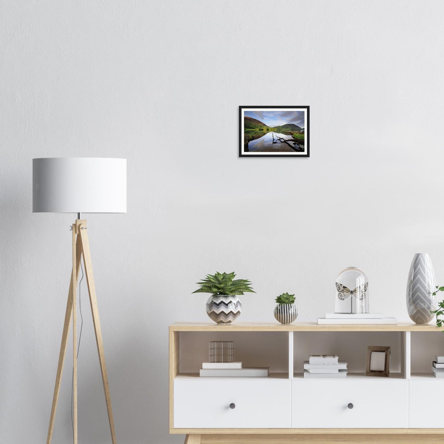 Solitary branch lying in still Crummock Water framed art