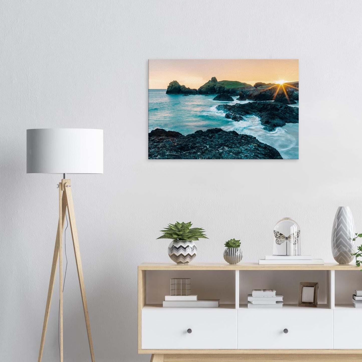 Kynance Cove shoreline glowing with warm light under a vivid sunset sky