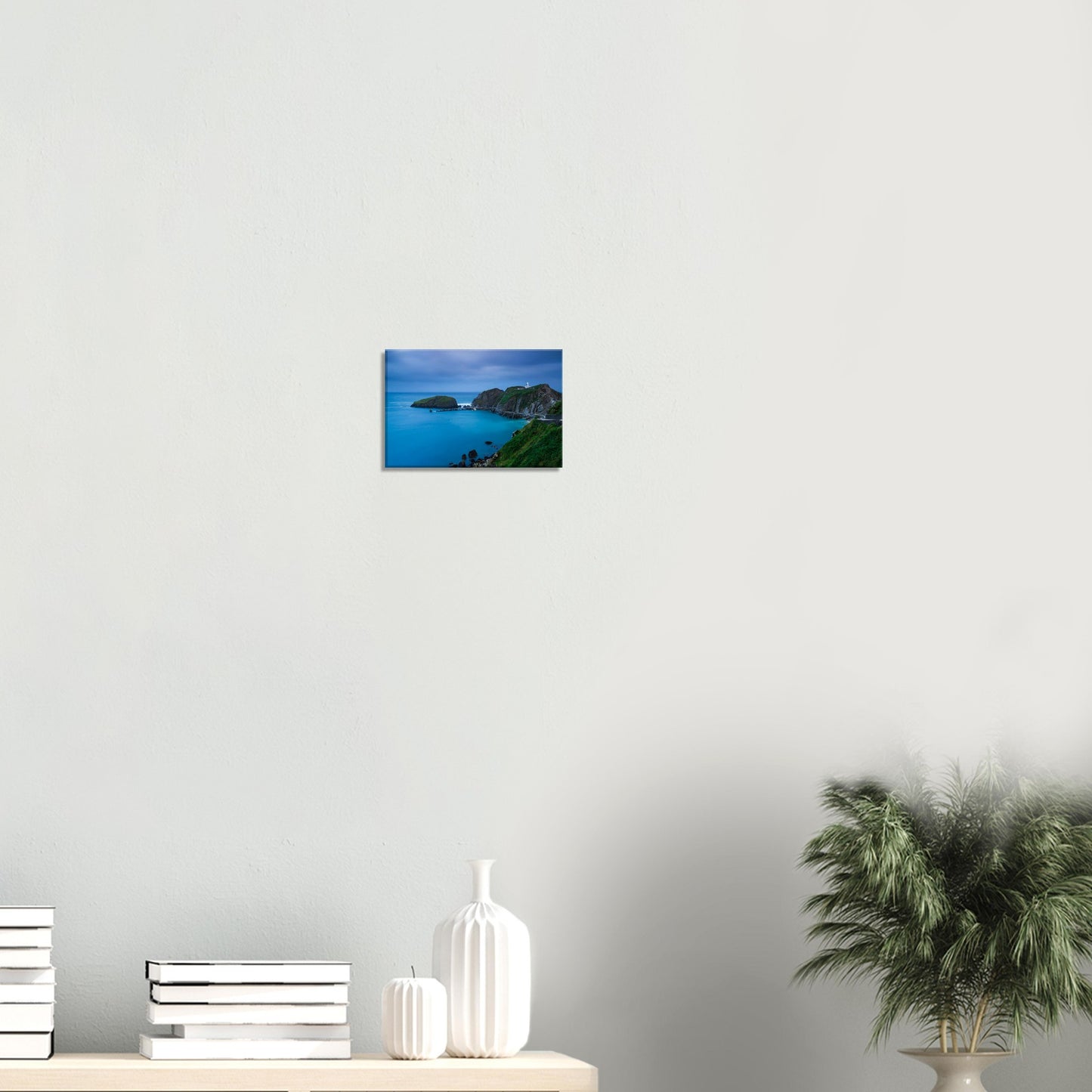 Scenic canvas artwork showing Lundy Island’s rugged coastline at dusk, with a lighthouse and serene waters under a soft blue sky.