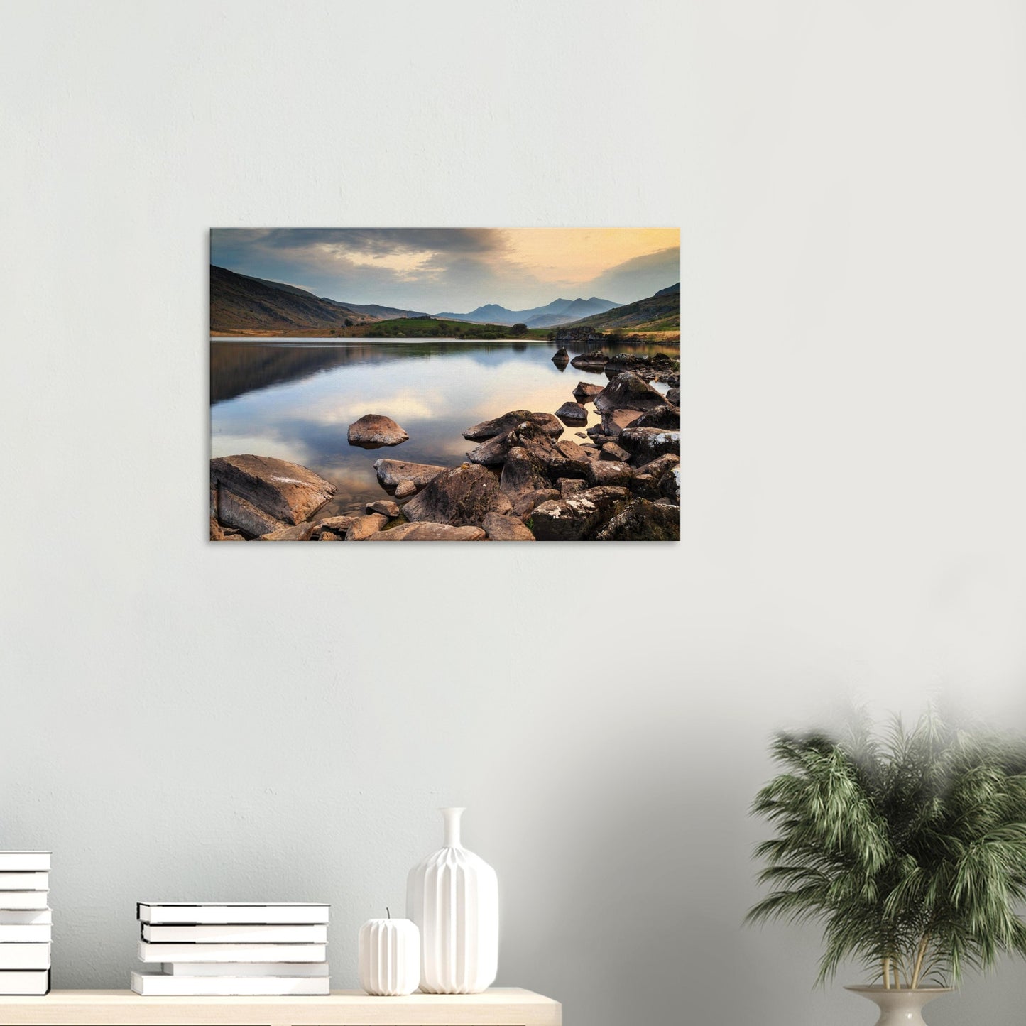 Golden hour light illuminating Llynnau Mymbyr with calm water and rugged Welsh peaks in background