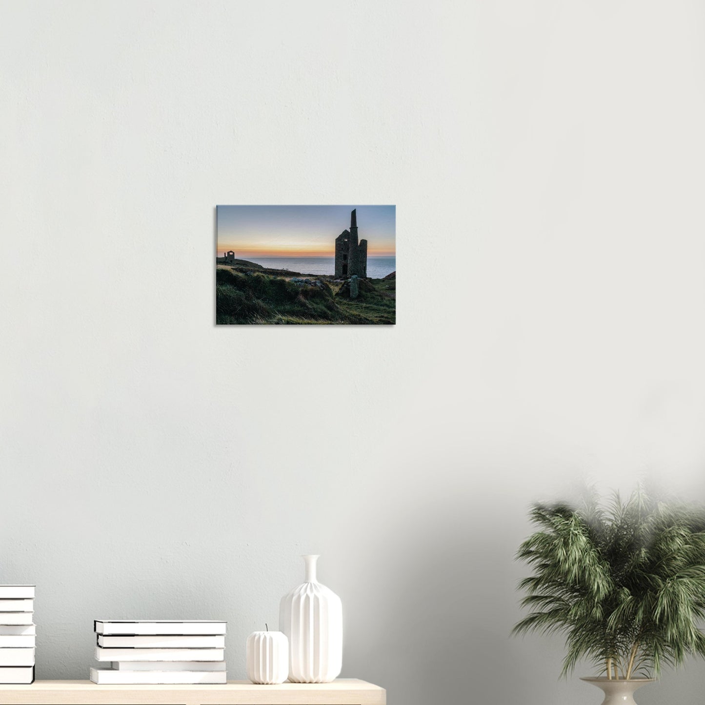 Iconic silhouette of the Wheal Owles engine house with soft pastel skies in the background