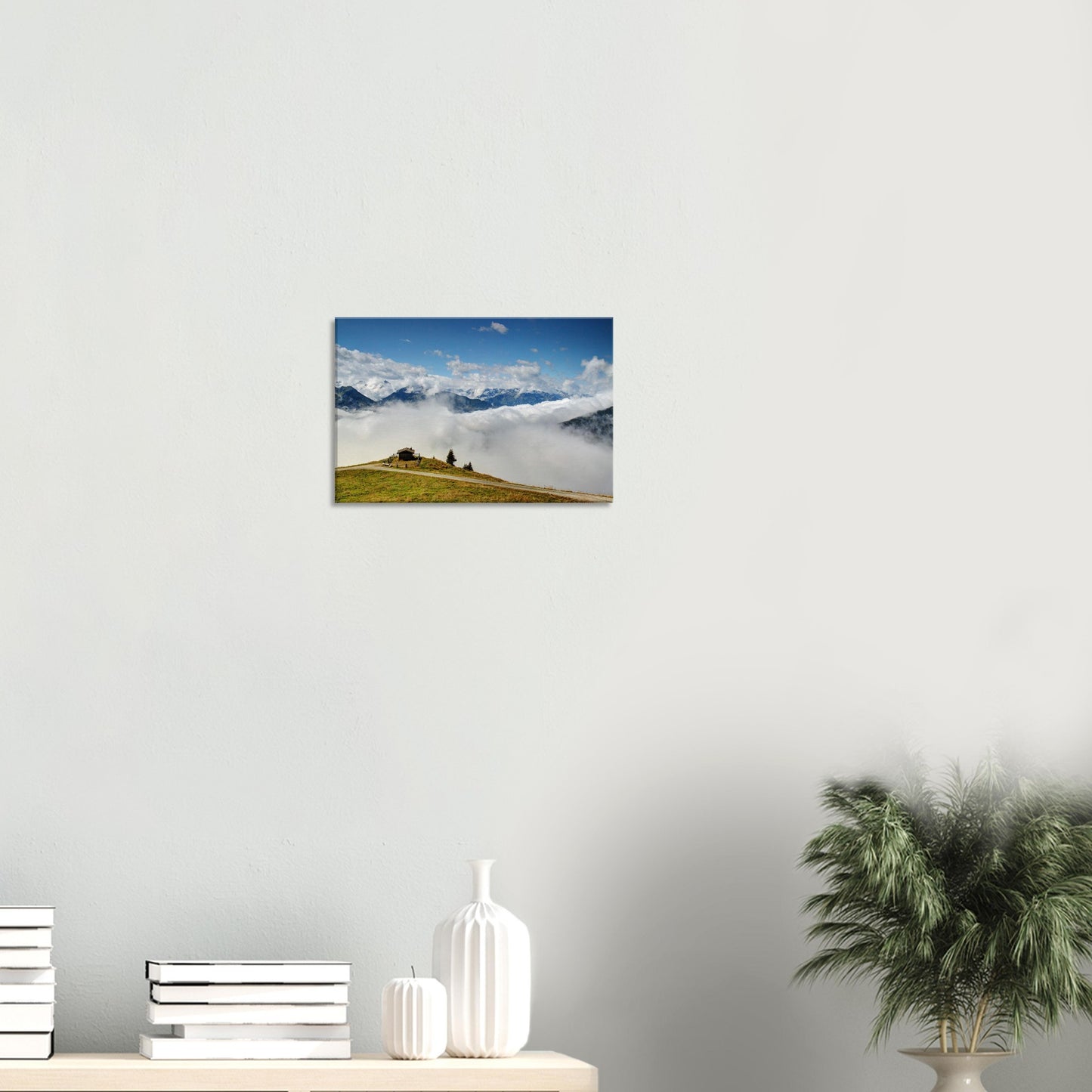 Canvas print of Resterhöhe in the Austrian Alps, featuring blue skies, mountain peaks, a sea of clouds, and a remote hilltop hut.