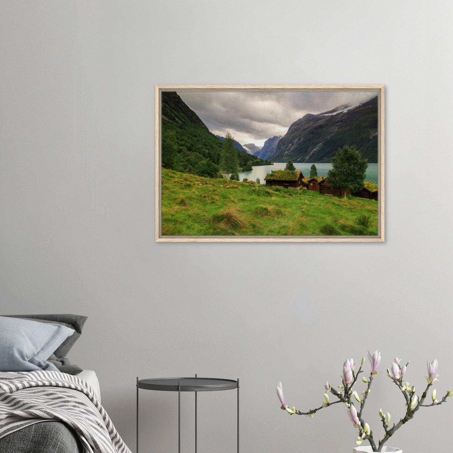 Traditional grass-roof cabins by lake in Norwegian landscape