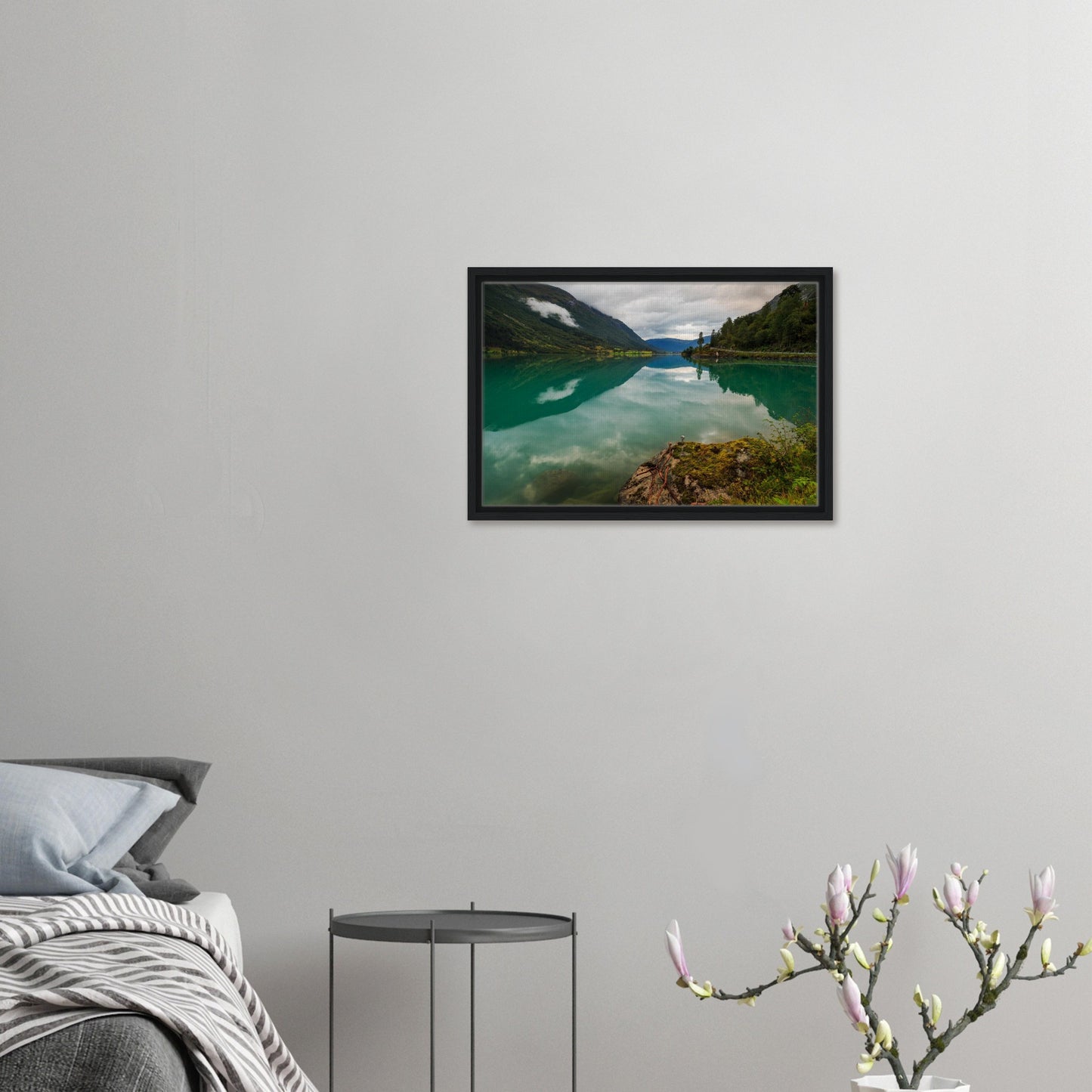 Moss-covered outcrop pointing to serene Norwegian lake