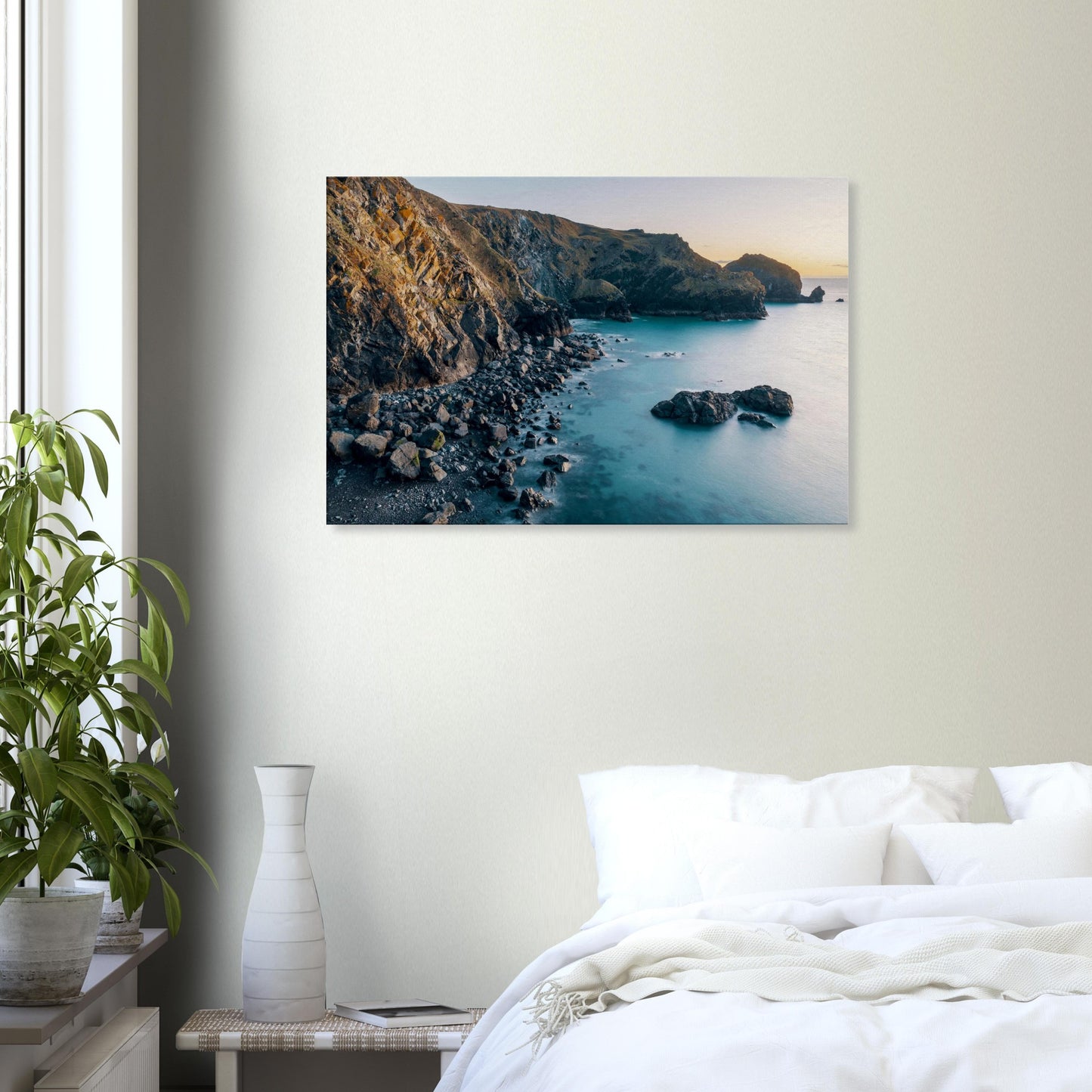Fading daylight shimmering across the water and illuminating the rocks at Mullion Cove