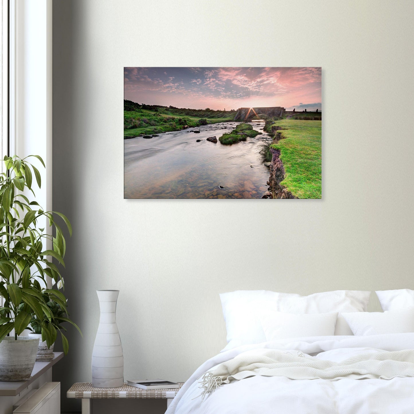 Sunlight breaking over Dartmoor hills and historic bridge scene