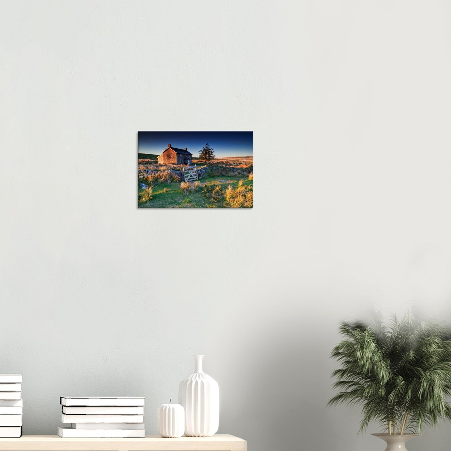 Tranquil Dartmoor dawn scene with farmhouse and glowing moorland.