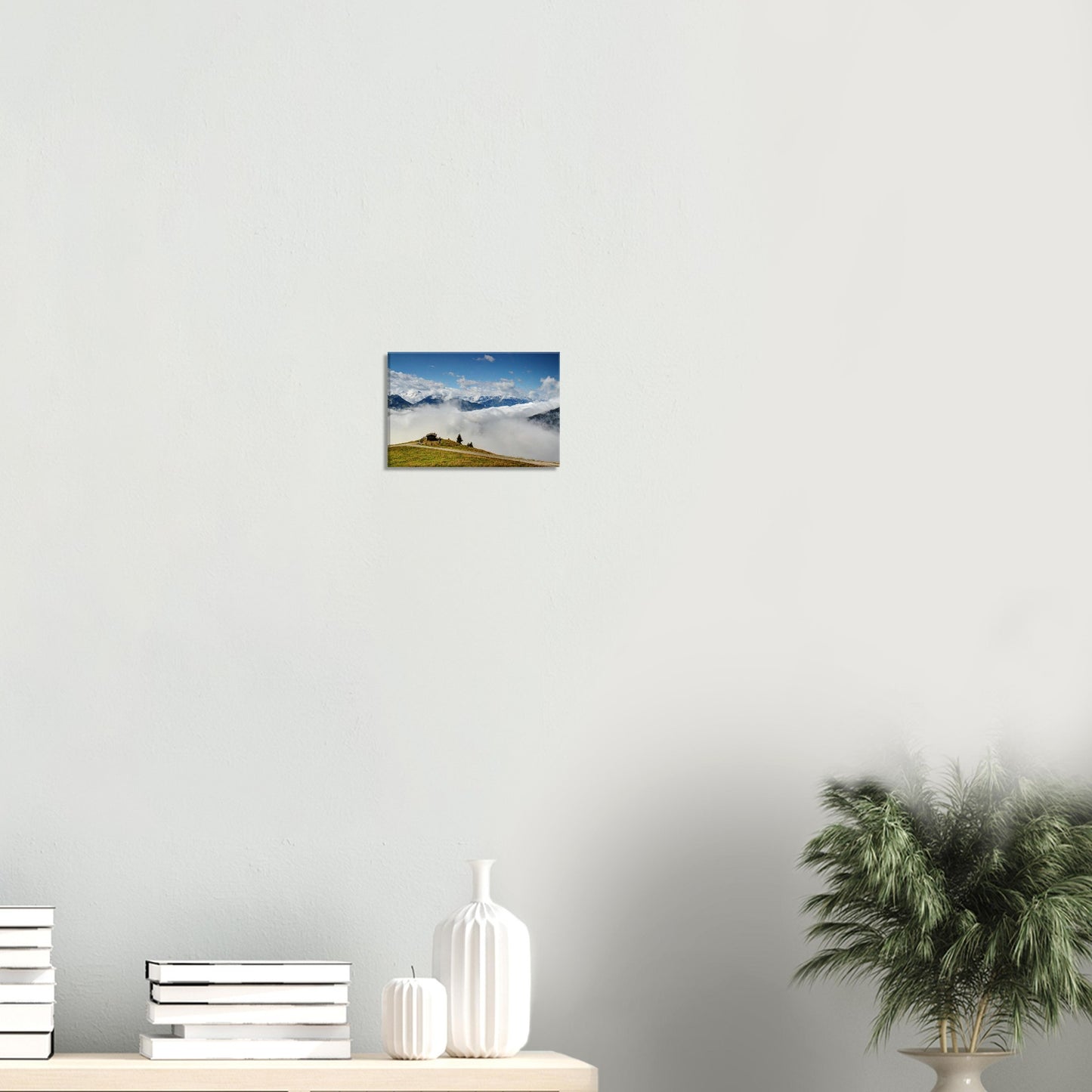 Panoramic landscape canvas of Resterhöhe in Austria, with a lone mountain hut above clouds and majestic alpine mountains in the background.