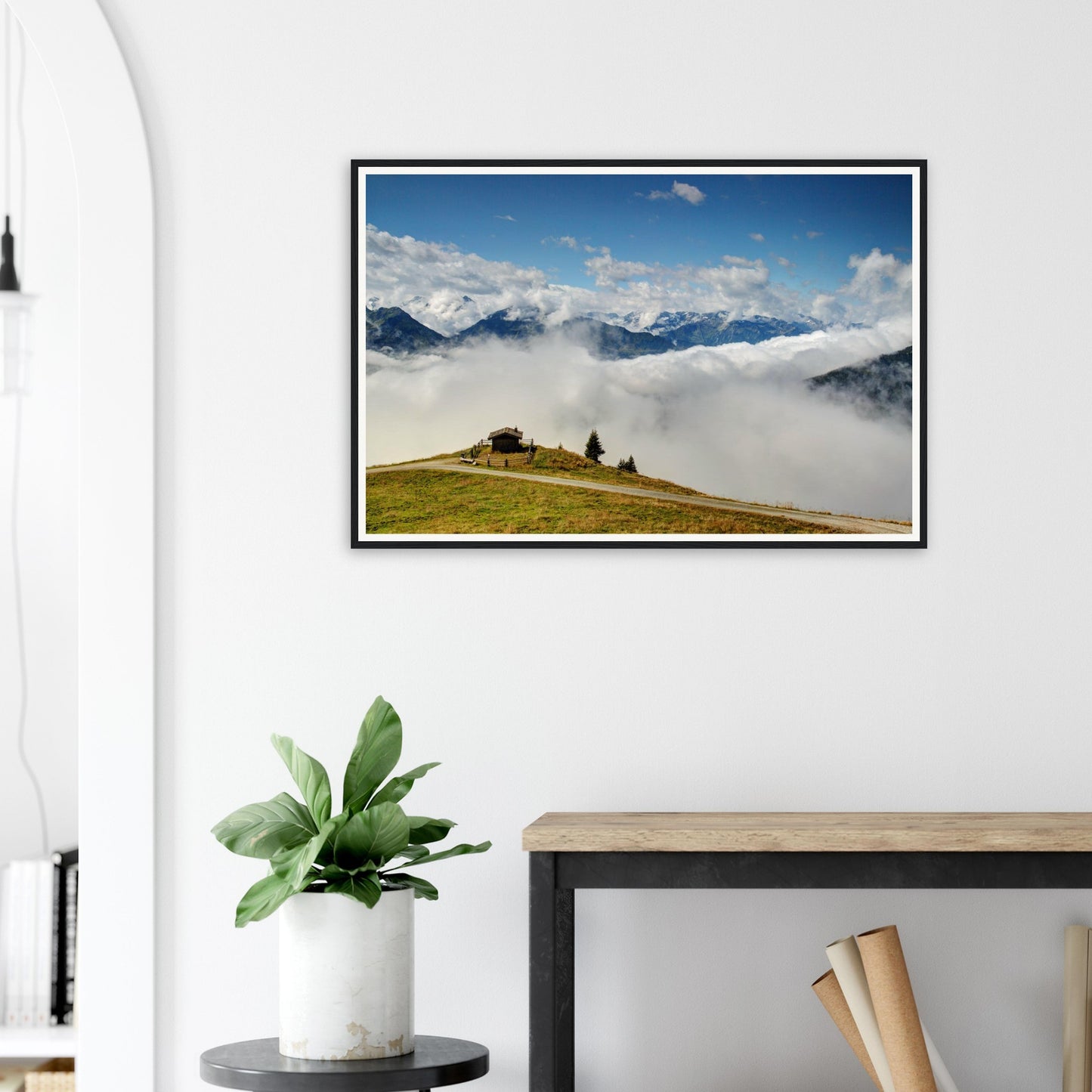 Framed wall art of Austria’s alpine peaks above the clouds