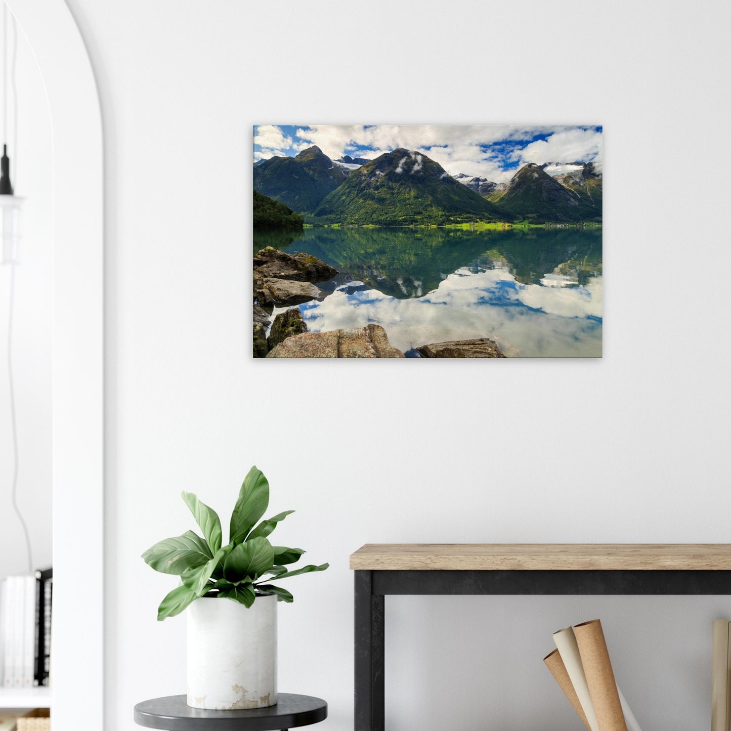 Peaceful Norwegian mountain lake surrounded by vibrant green slopes and mirrored skies on water surface