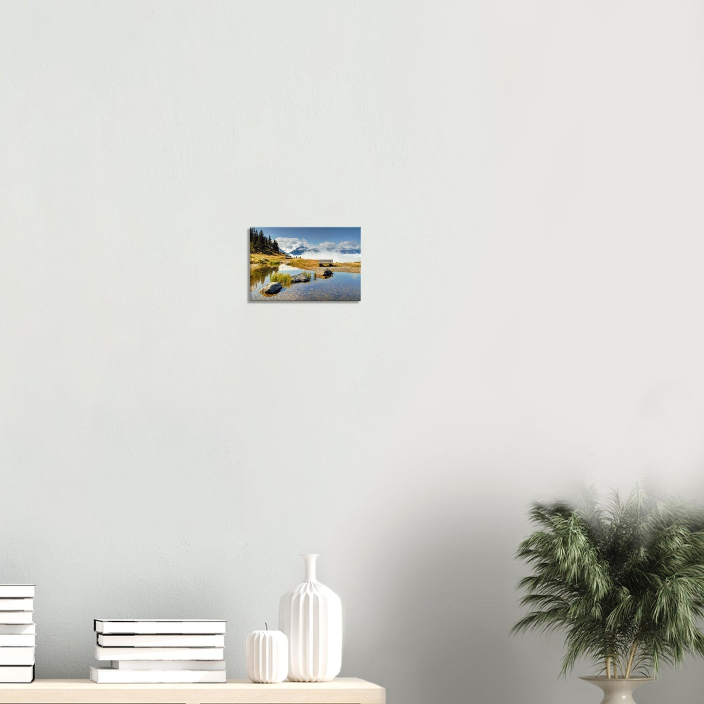 Canvas print of Panoramabahn showing alpine serenity with a bench beside a pond and clouds moving through distant mountain valleys.