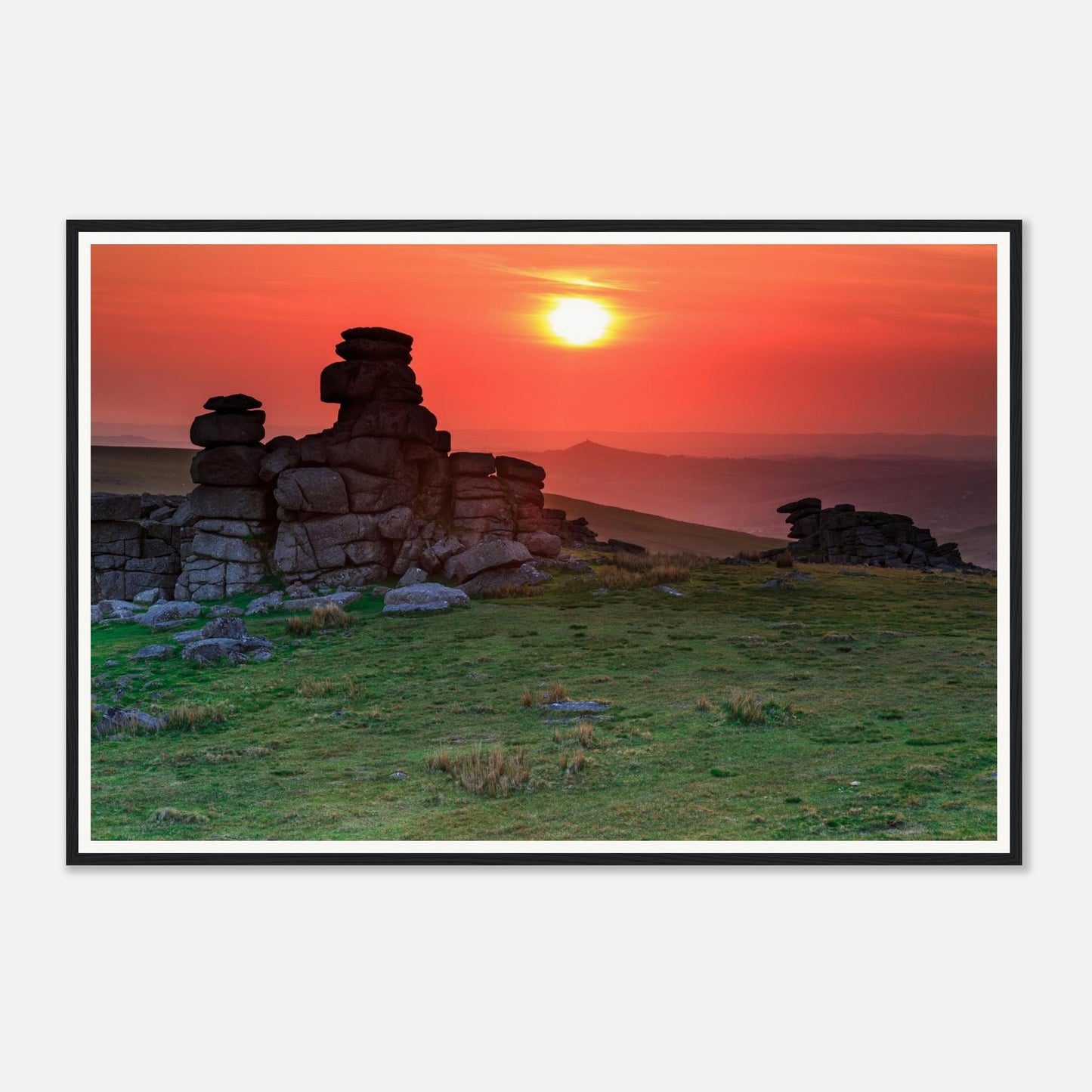 Fiery sunset sky silhouetting granite outcrops at Great Staple Tor