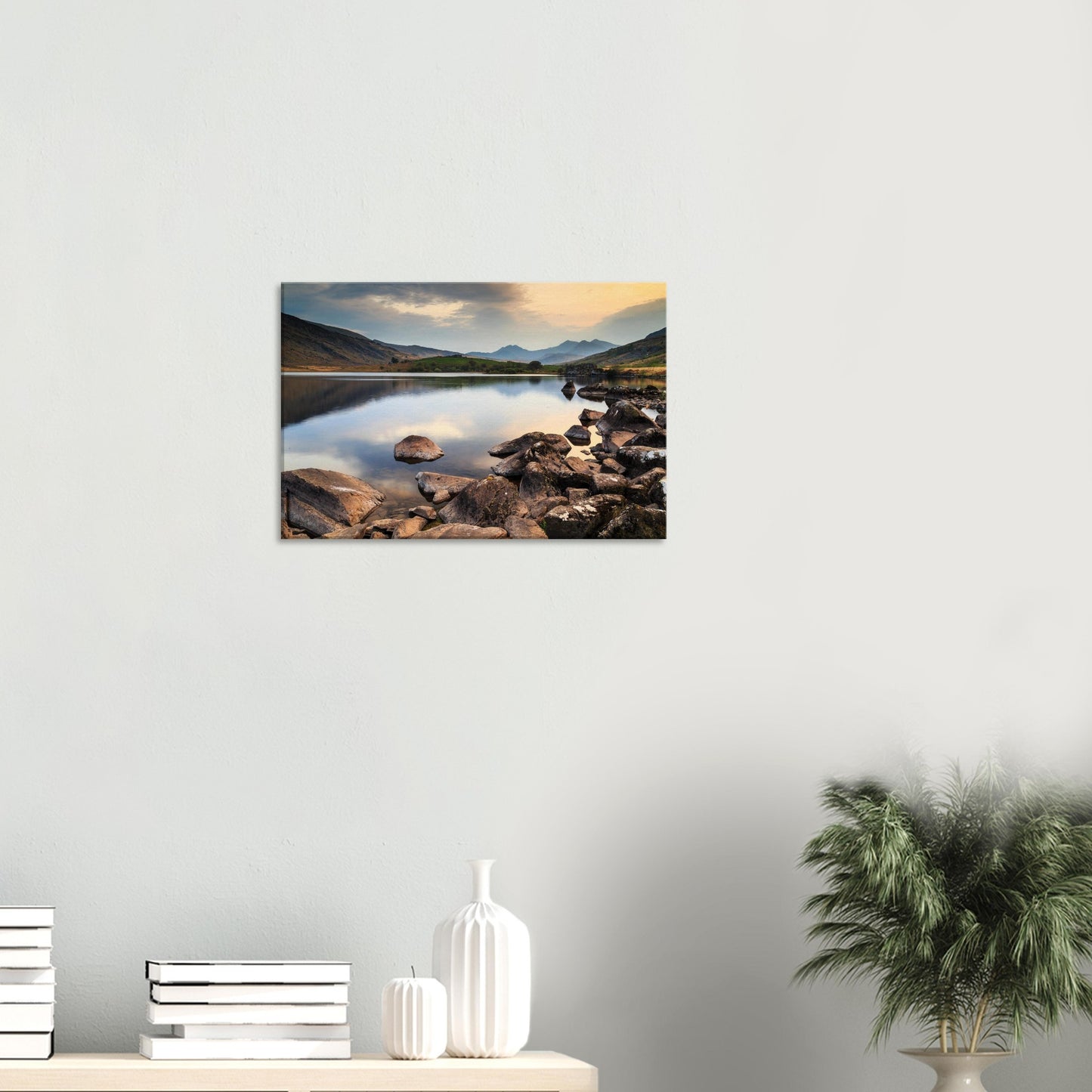 Quiet lakeside view featuring natural rock formations and gentle reflections under twilight sky