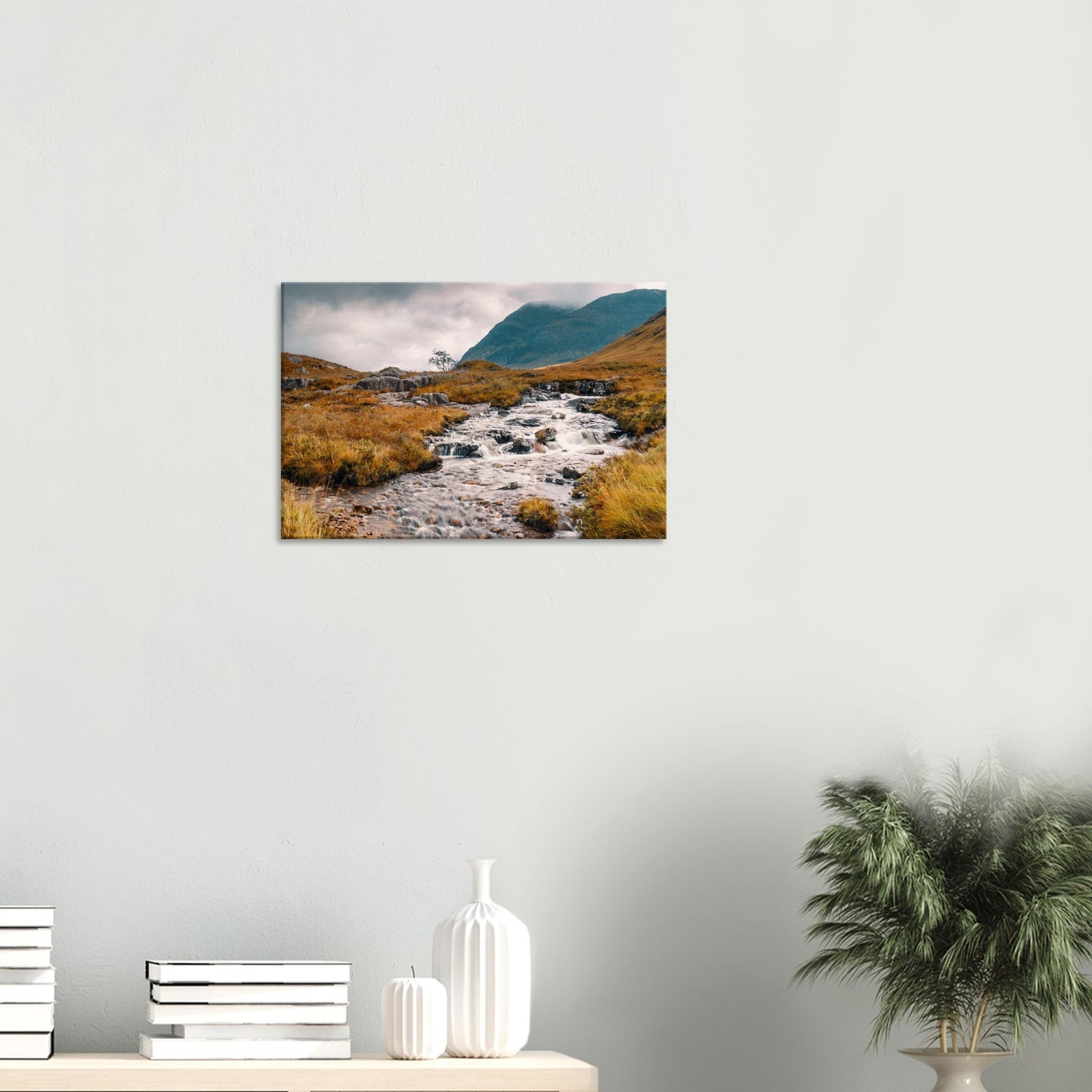 Glencoe landscape featuring fast-flowing stream and misty mountains