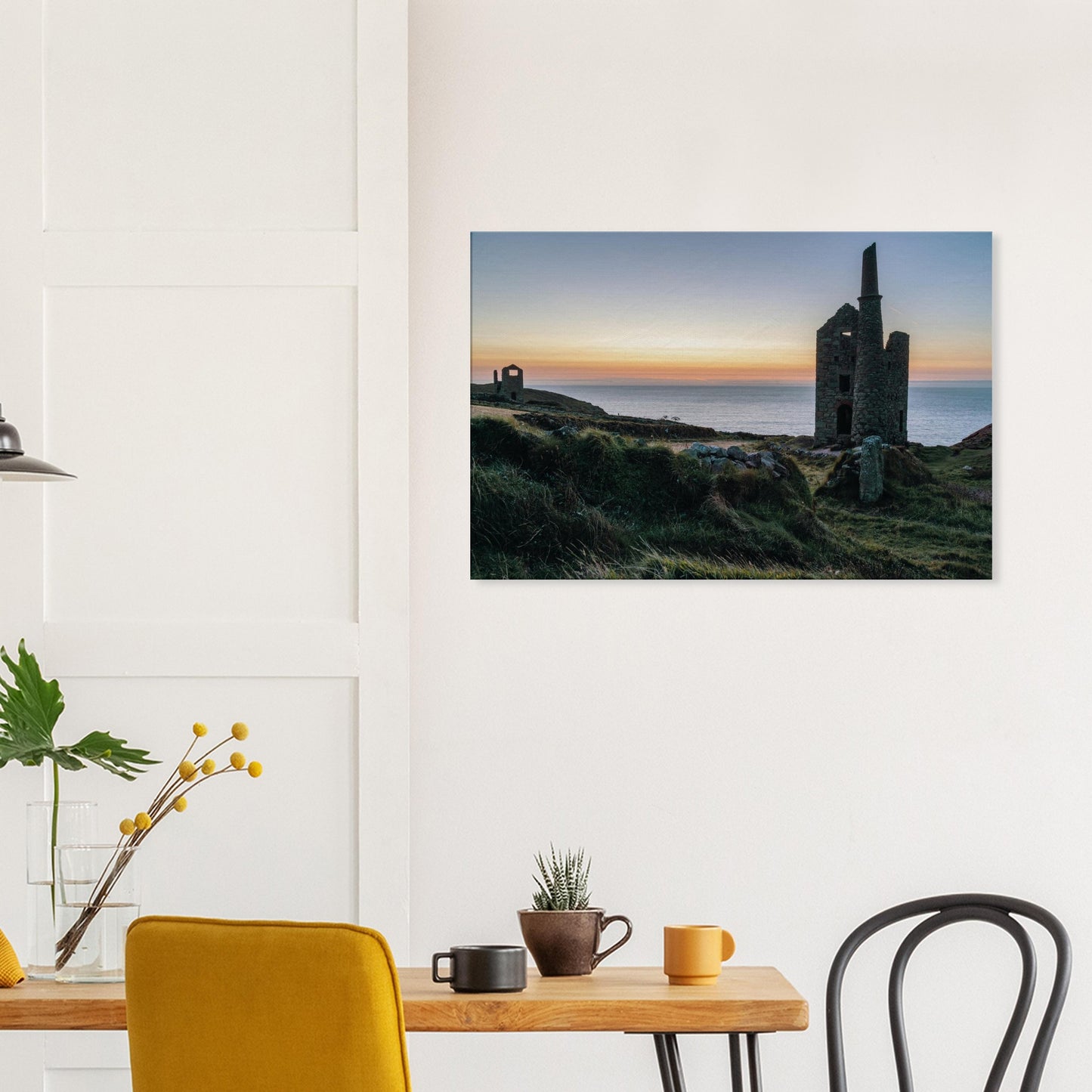 Stone ruins of a 19th-century tin mine at Wheal Owles illuminated by golden-hour light