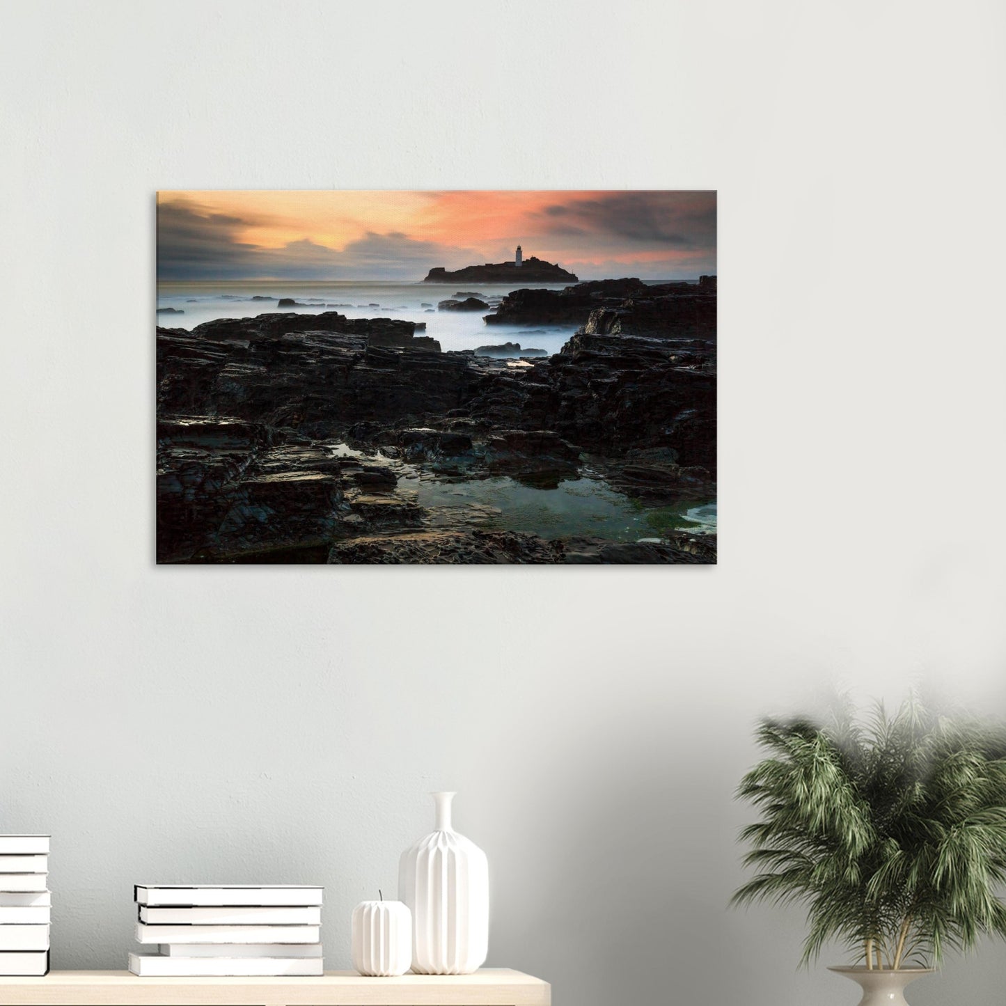 Sunset canvas print of Godrevy Lighthouse with golden hour sky and dramatic coastal rocks.