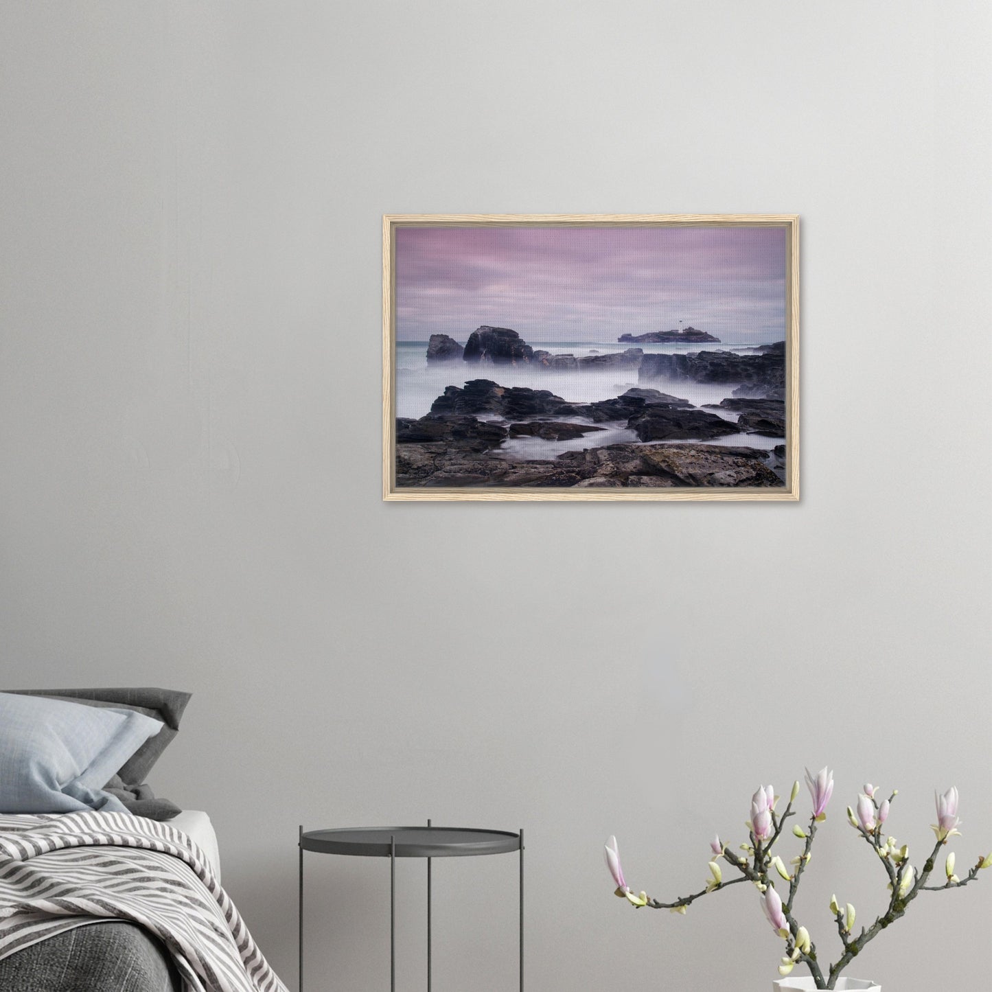 Black jagged rocks and lighthouse in Cornwall canvas print
