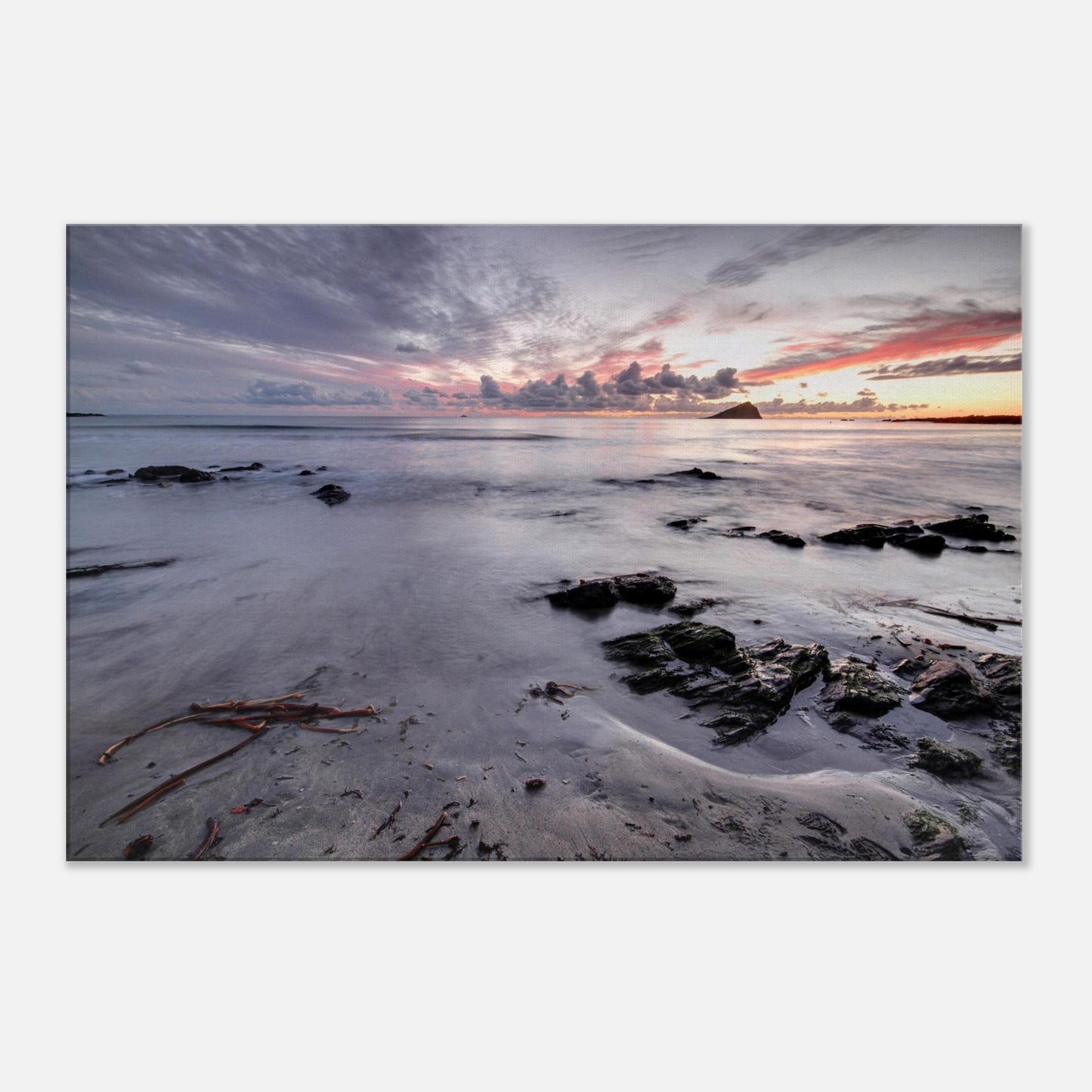 Canvas artwork of Wembury Beach sunset, featuring golden hour light, calm tide, scattered coastal rocks, and the dark silhouette of Mewstone island.