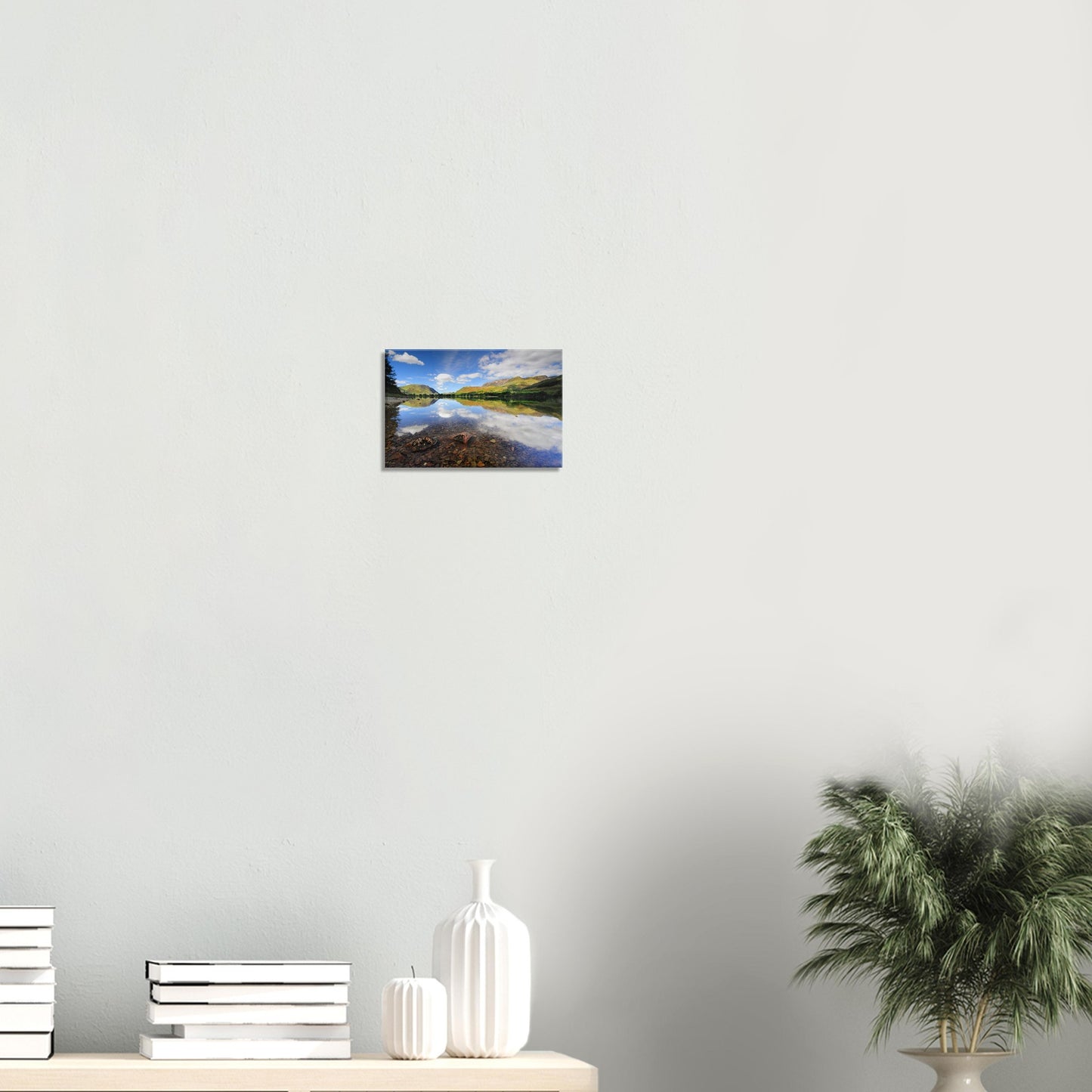 Lake District canvas print capturing Buttermere’s clear lakebed, lush reflected fells, and a serene sky filled with soft, white clouds.