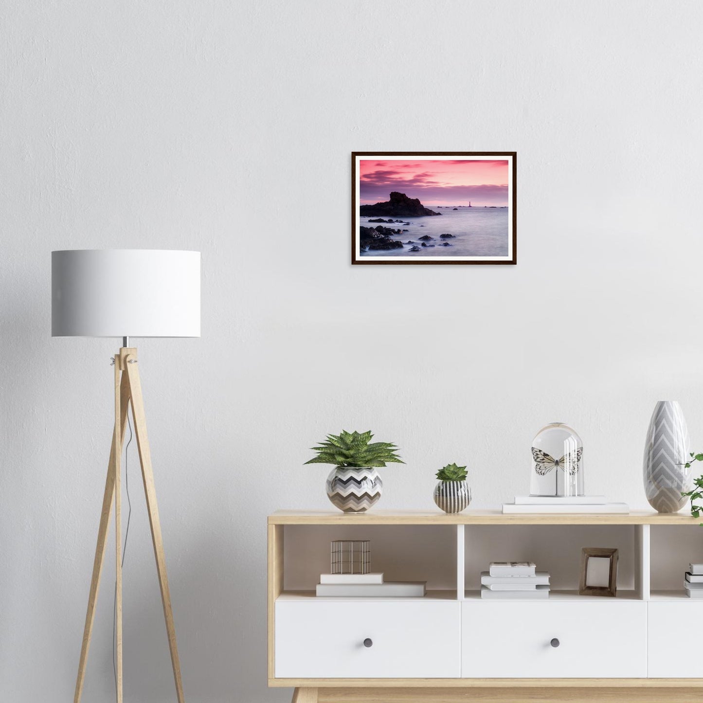 Dramatic silhouette of Les Hanois Lighthouse against sunset framed art
