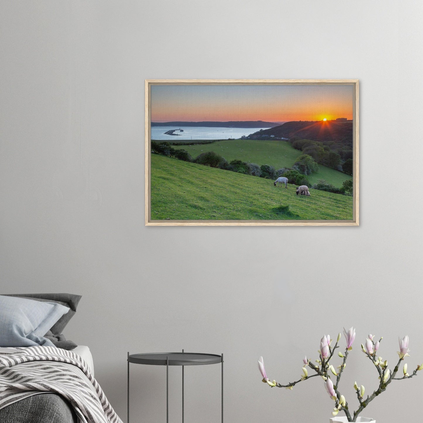 Framed landscape art of sheep and sea in golden light