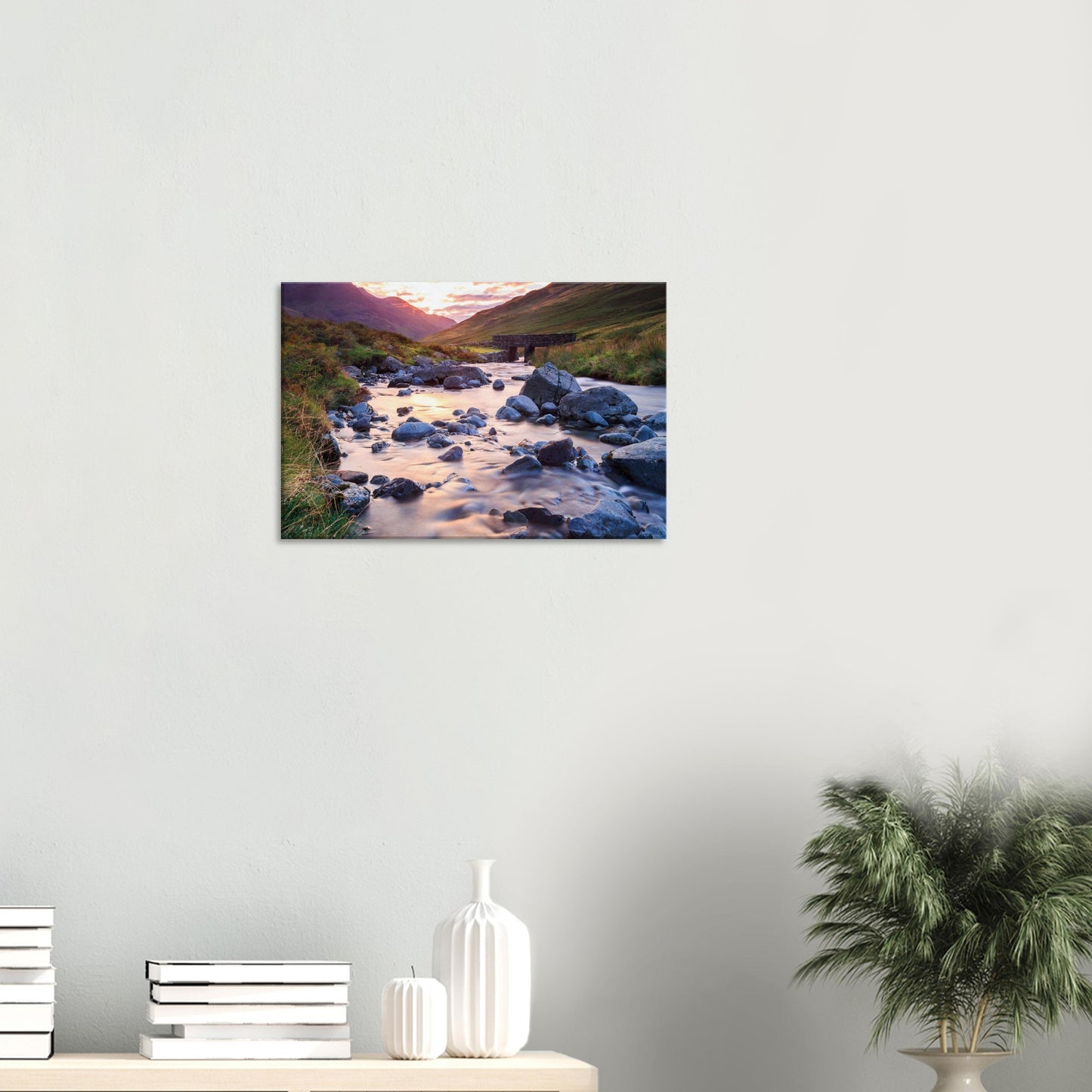 Canvas featuring the natural splendour of Honister Pass with glowing golden hour light, a flowing stream, and a stone bridge.