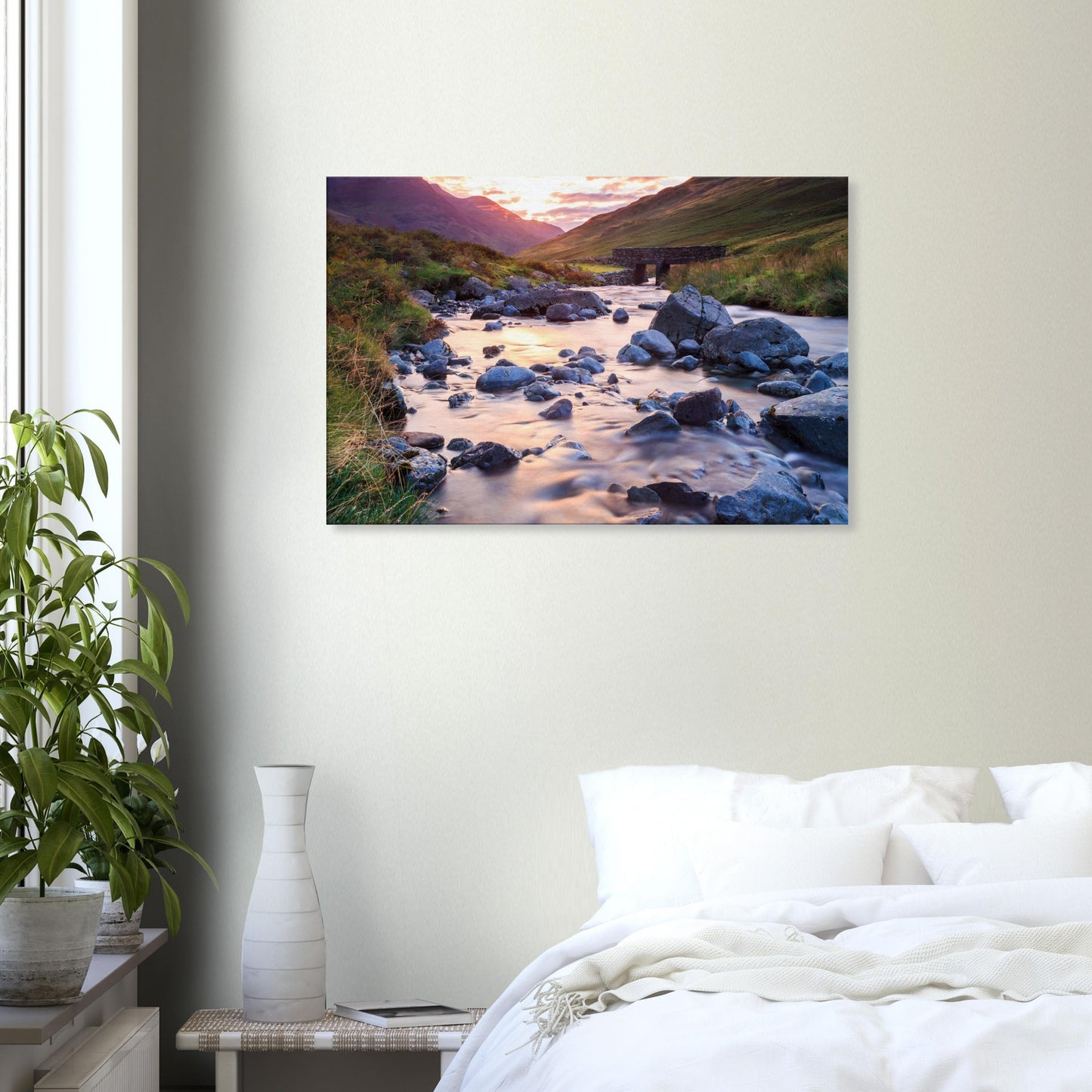 Landscape canvas of Honister Pass in warm sunset tones, featuring a calm stream winding through a rugged valley with a stone bridge.