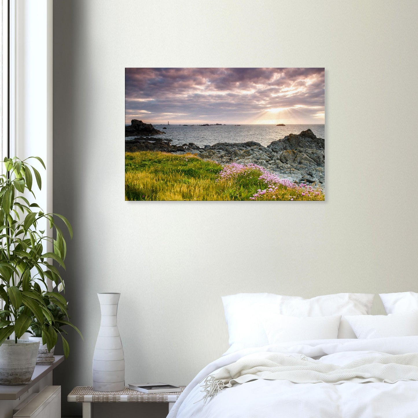Canvas scene of Pleinmont Point’s rugged coast bathed in sunset glow, with Les Hanois Lighthouse lit by divine light rays.