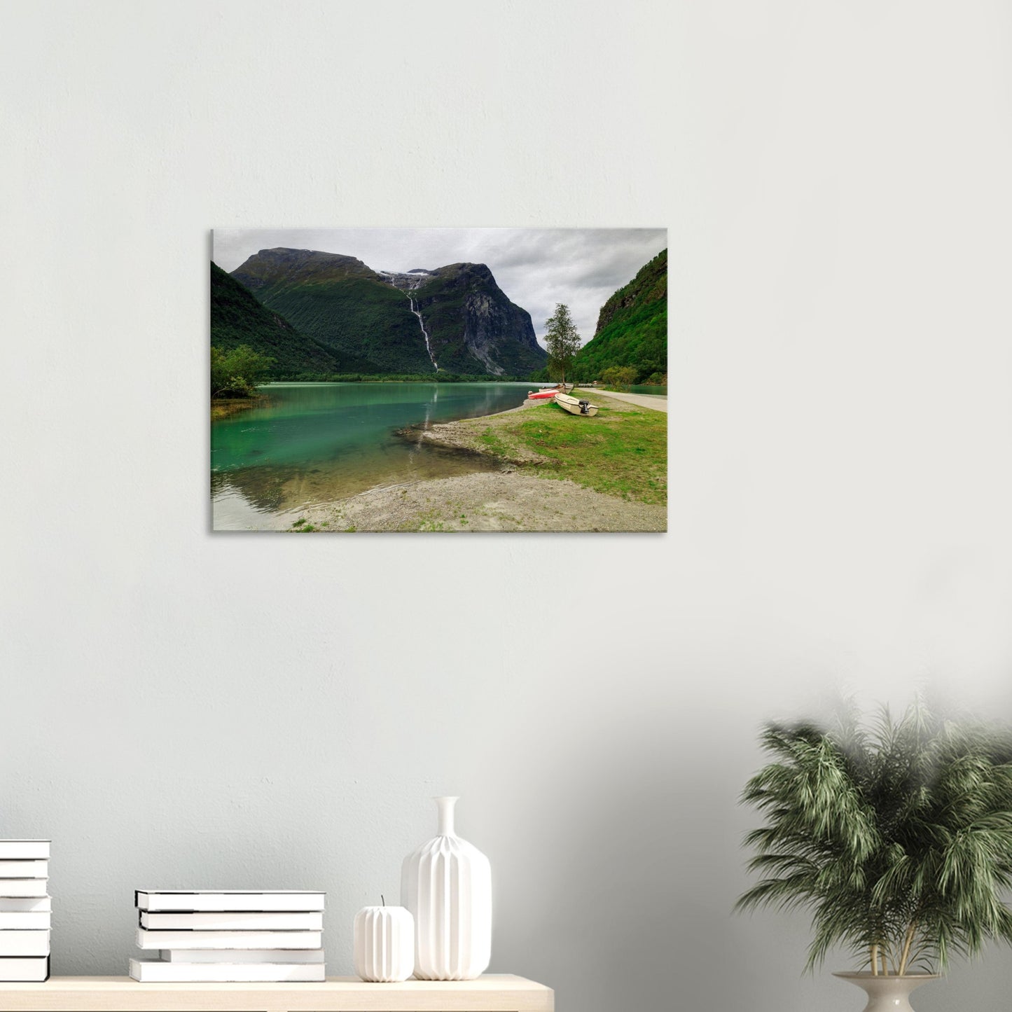 Scenic view of Norway’s Mount Ramnefjell beside the sparkling waters of Utigardsfossen Waterfall and emerald lake