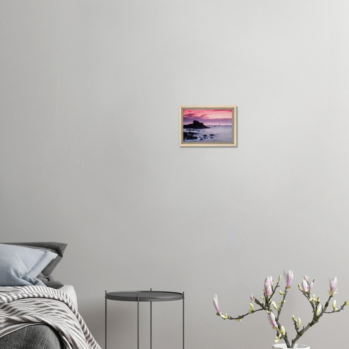Guernsey coast at twilight with lighthouse and calm sea in frame
