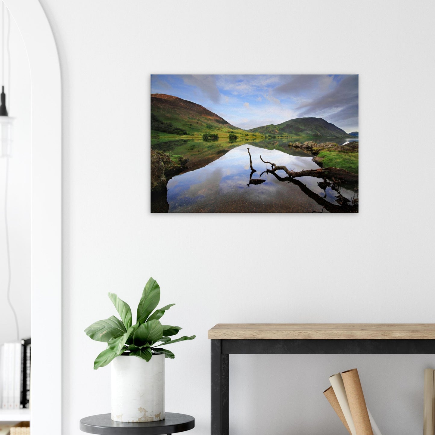 Canvas artwork of Crummock Water’s peaceful lake, with a solitary branch in the foreground and clear reflections of surrounding fells.