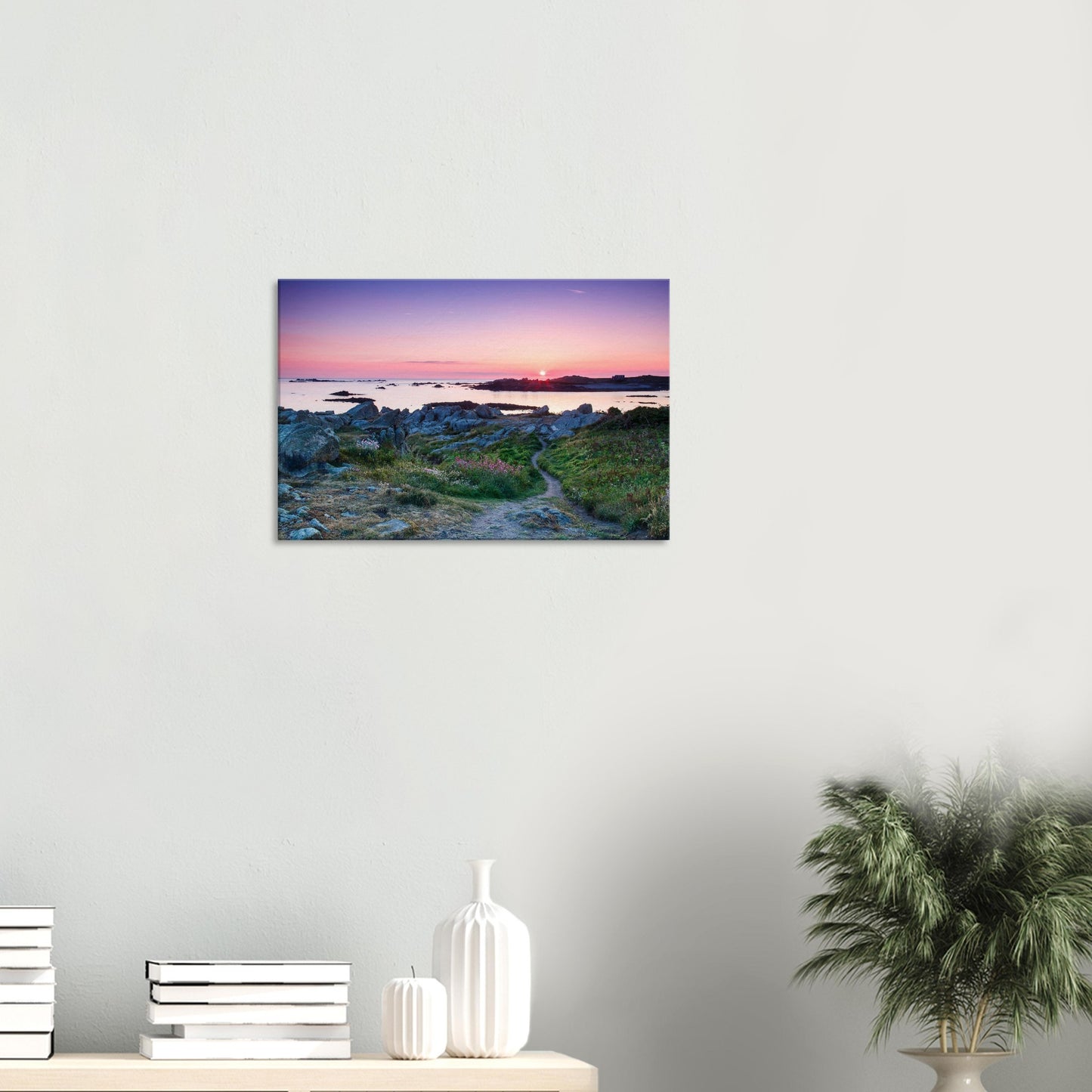 Scenic canvas of Lihou Island with warm sunset light over rocks, colourful wildflowers, and a path leading into the horizon.