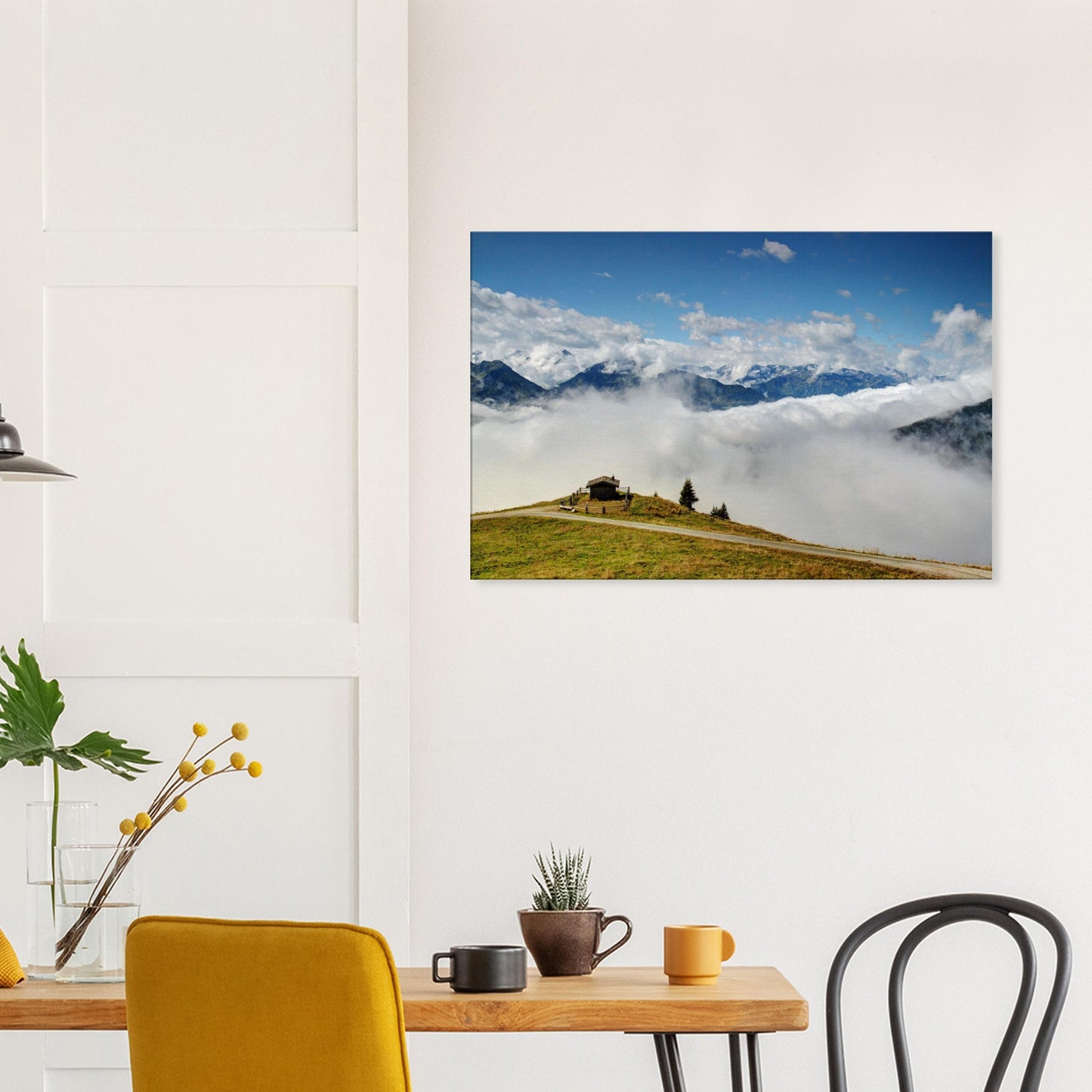 Canvas print of Panoramabahn with a solitary hut on a grassy ridge, clouds settled below, and the Austrian Alps stretching into the horizon.