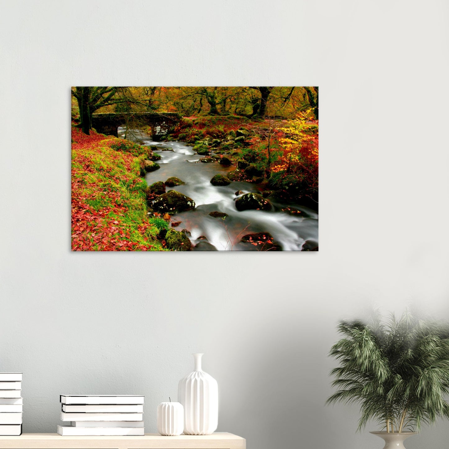 Autumn forest scene with stone bridge over stream in Dartmoor