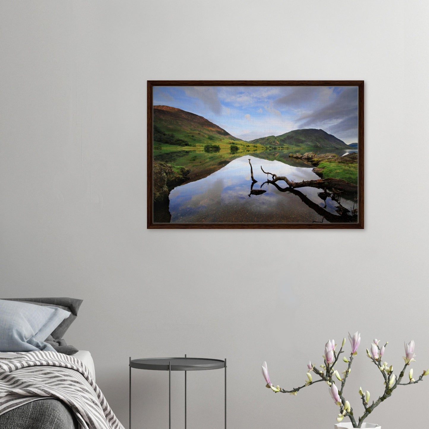 Tranquil Lake District scene with mirrored sky and branch