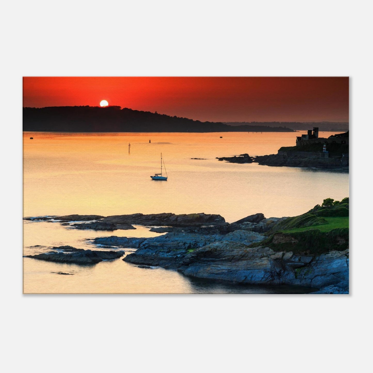 Devon coastline at sunset captured on canvas, with historic fort and sailboat in the distance.