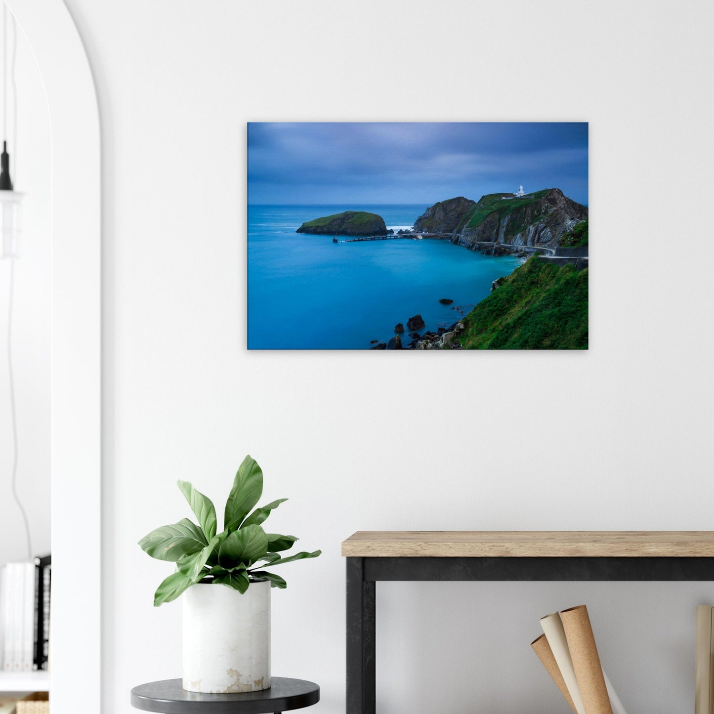 Moody blue hour canvas print showing Lundy Island’s Landing Bay with a slender pier leading to an isolated islet.